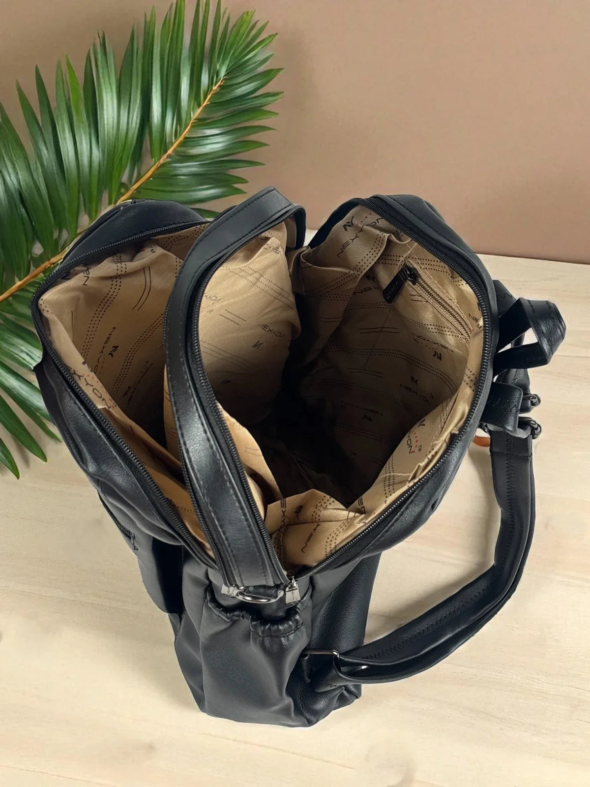Tarani black PU leather backpack spacious interior with compartments close-up