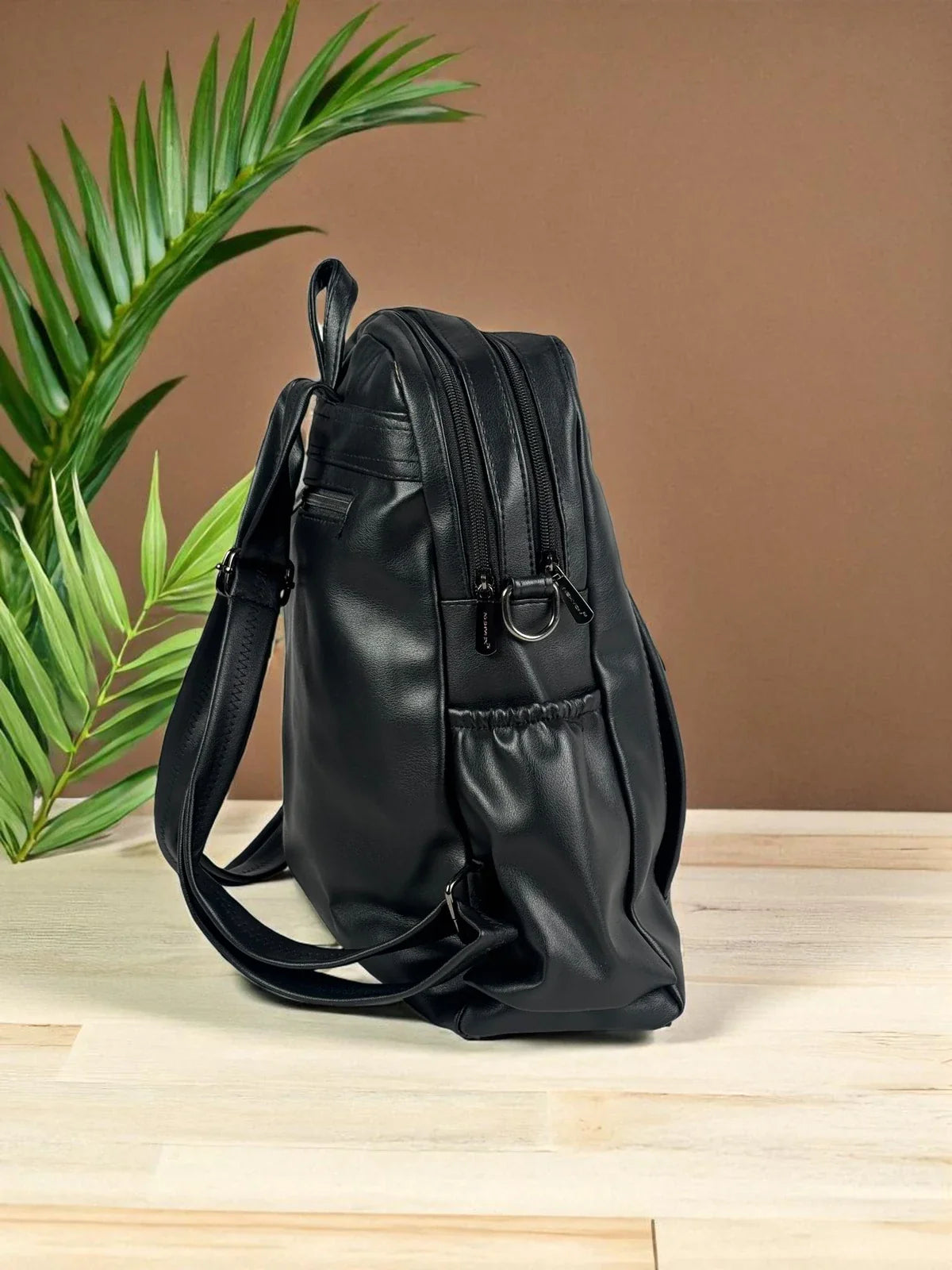 Tarani black PU leather backpack side view with durable finish and sleek design