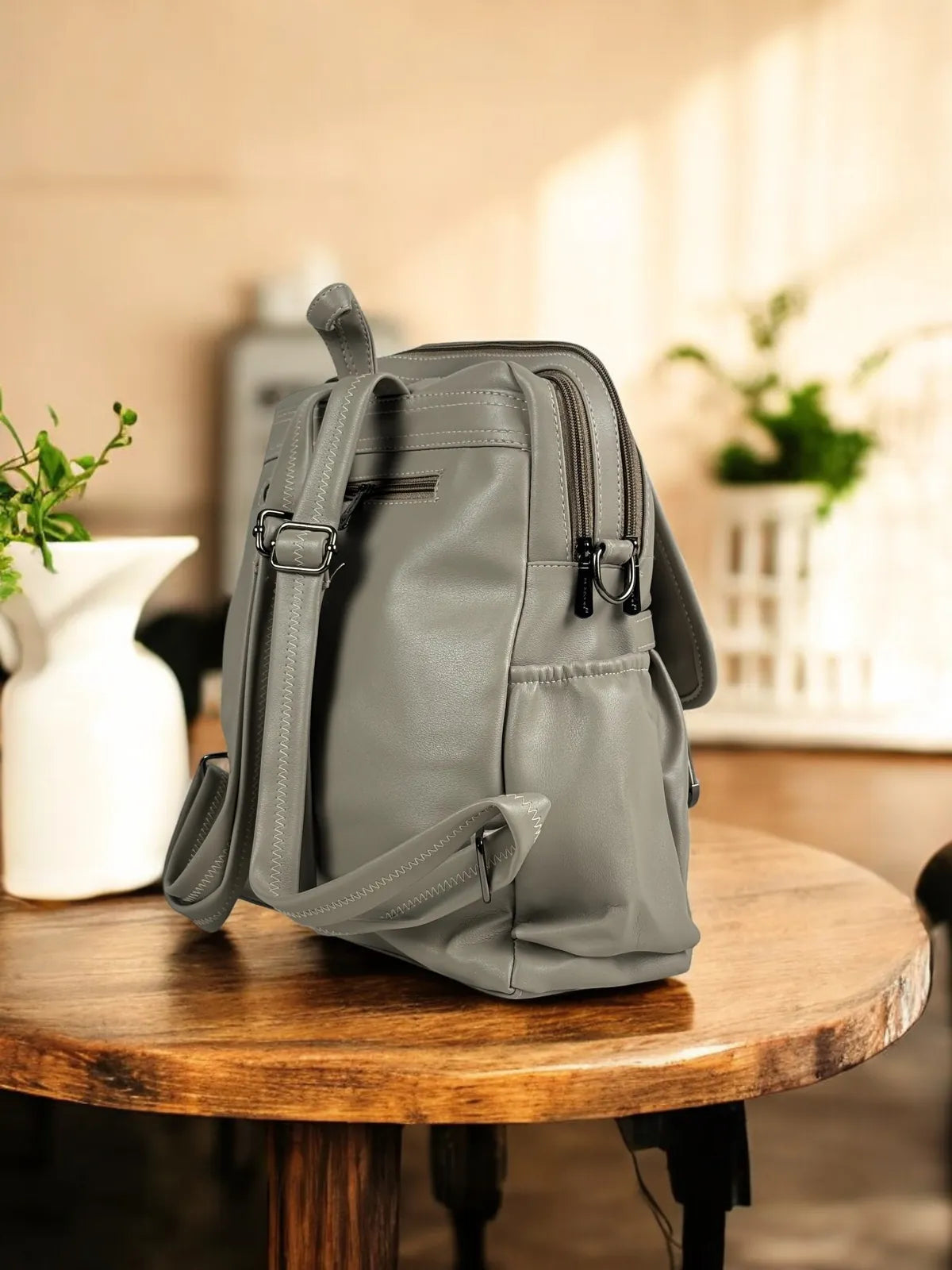 Tarani grey PU leather backpack side profile view