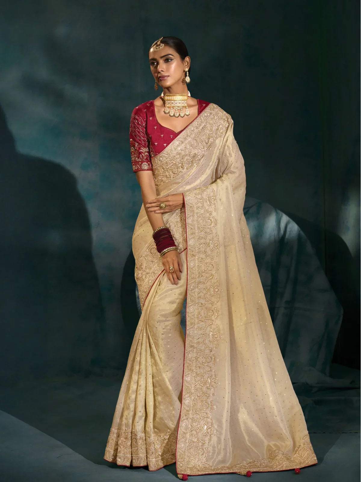 Tarani off white banarasi saree full view with golden embroidery and maroon silk blouse