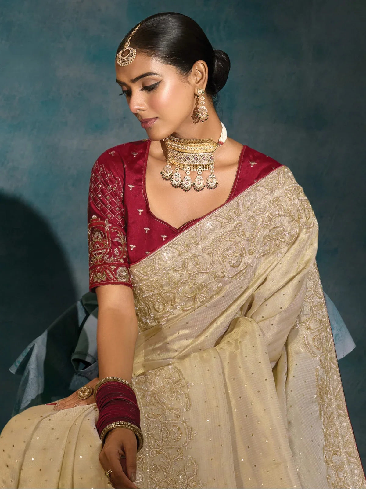 Tarani off white banarasi saree upper body view with maroon blouse and heavy jewellery