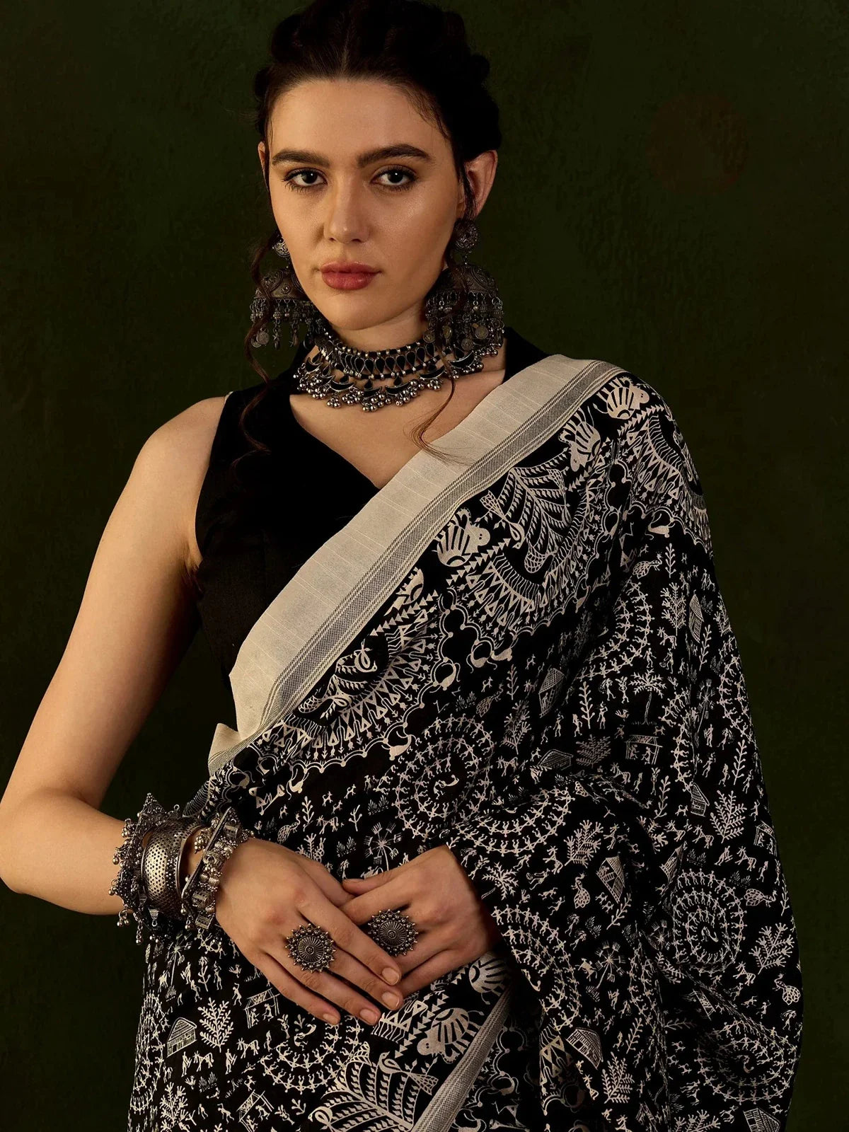 Tarani Bhagalpur black saree upper body closeup with intricate white warli print and cotton silk blouse