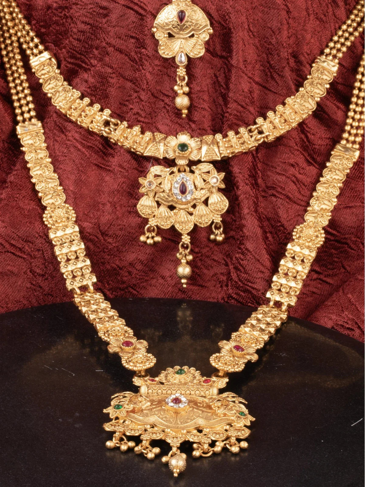 Tarani closeup view of gold plated bridal set showing necklace pendant and earrings for festive wear