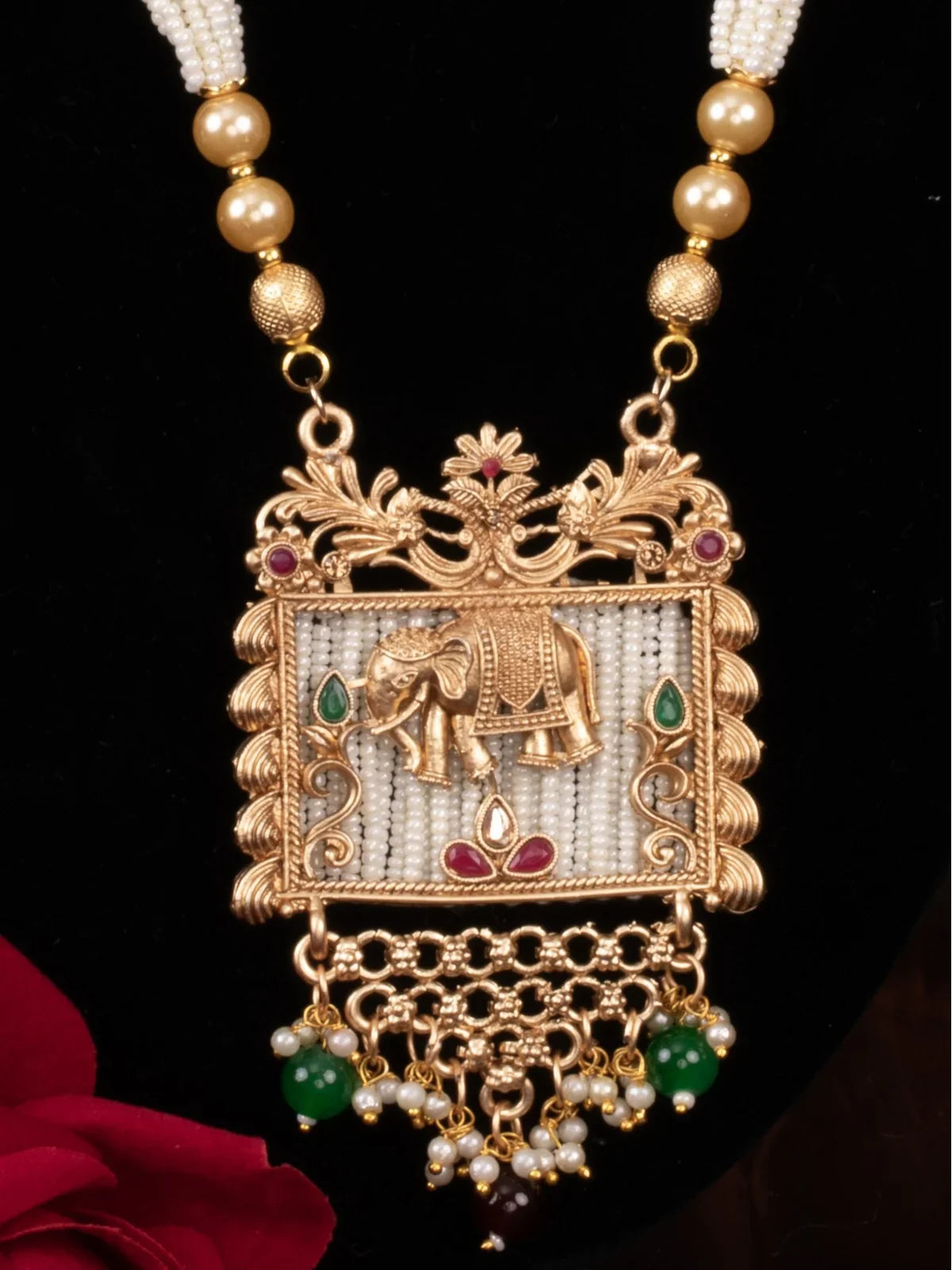 Tarani closeup of bridal set showing pearl strands and antique gold detailing