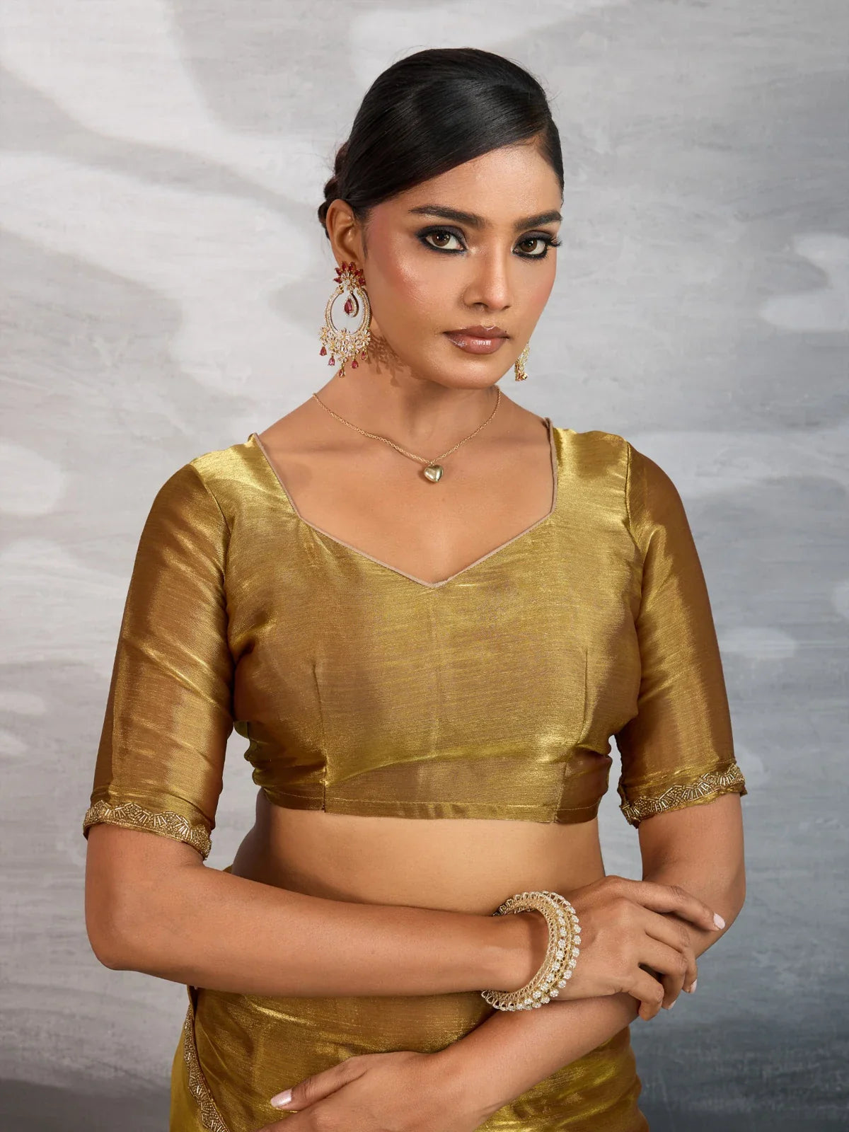 Tarani golden chiffon saree with running blouse and lace sleeve design close view