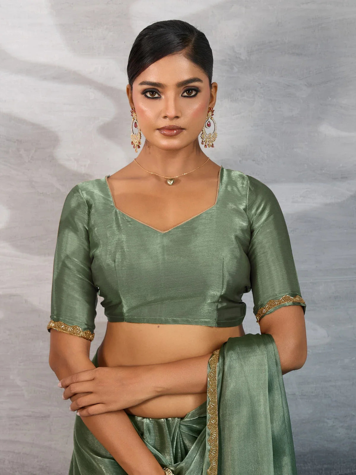 Tarani green chiffon saree front pose showcasing elegant drape and festive look