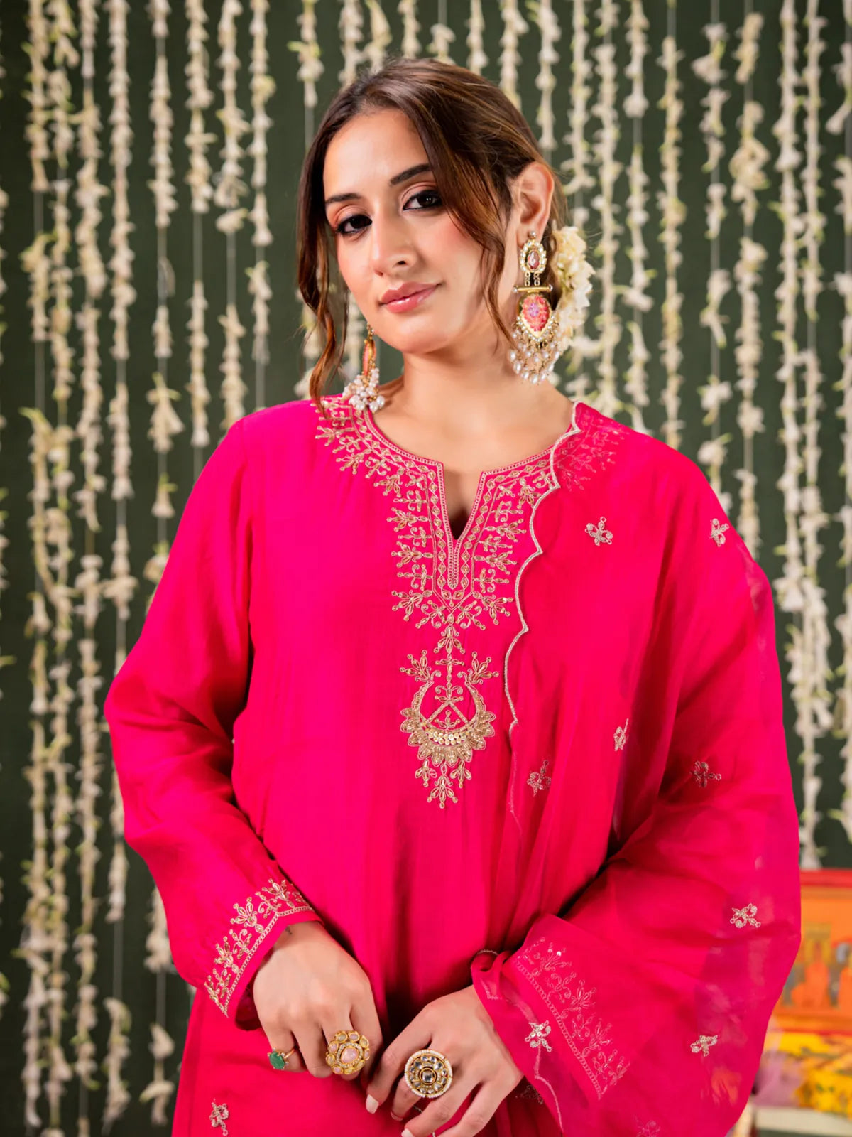 Tarani premium pink chanderi dress with embroidery work showing upper body and earrings