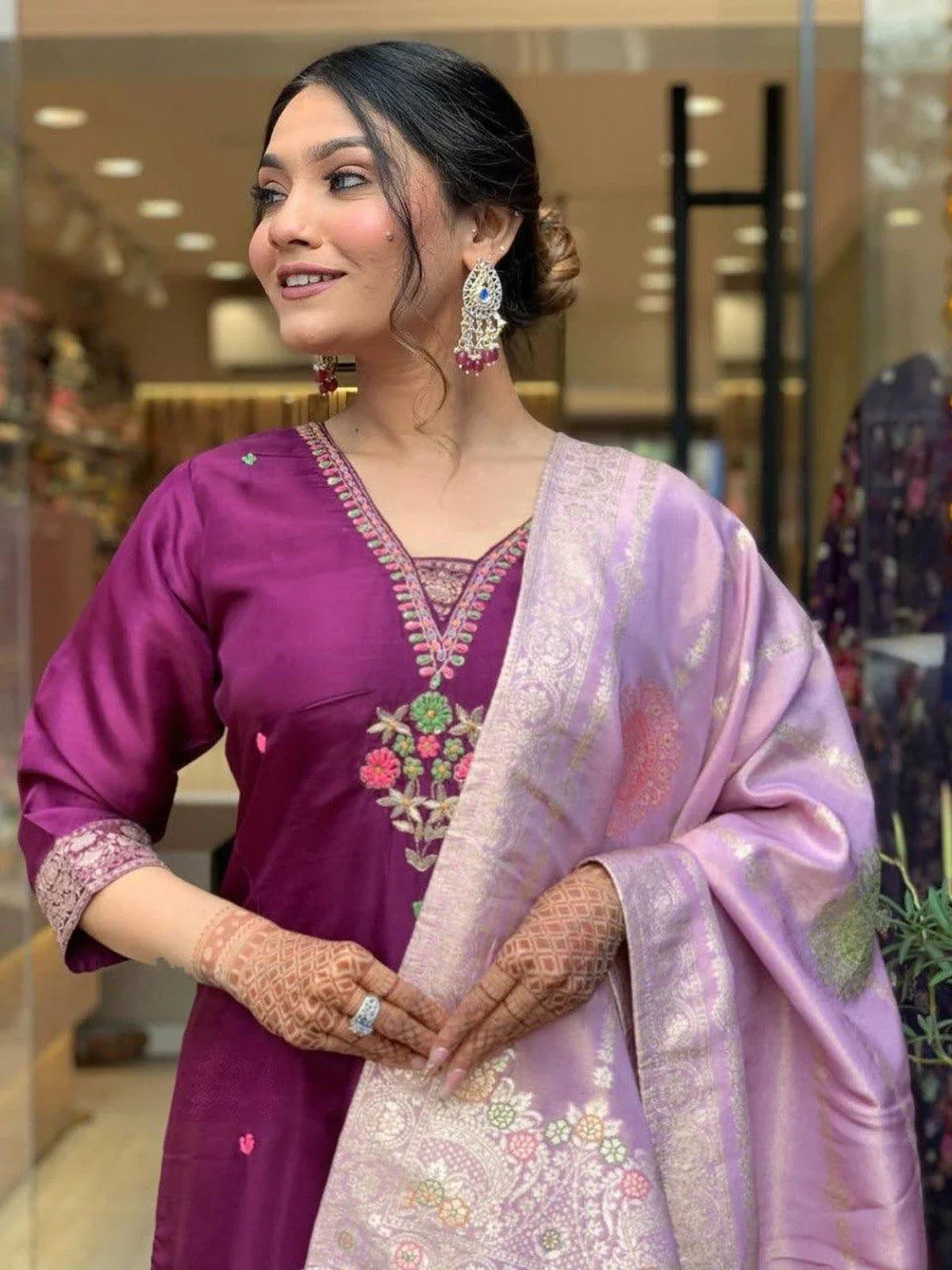 Tarani purple chanderi dress upper body view with detailed neckline embroidery and earrings