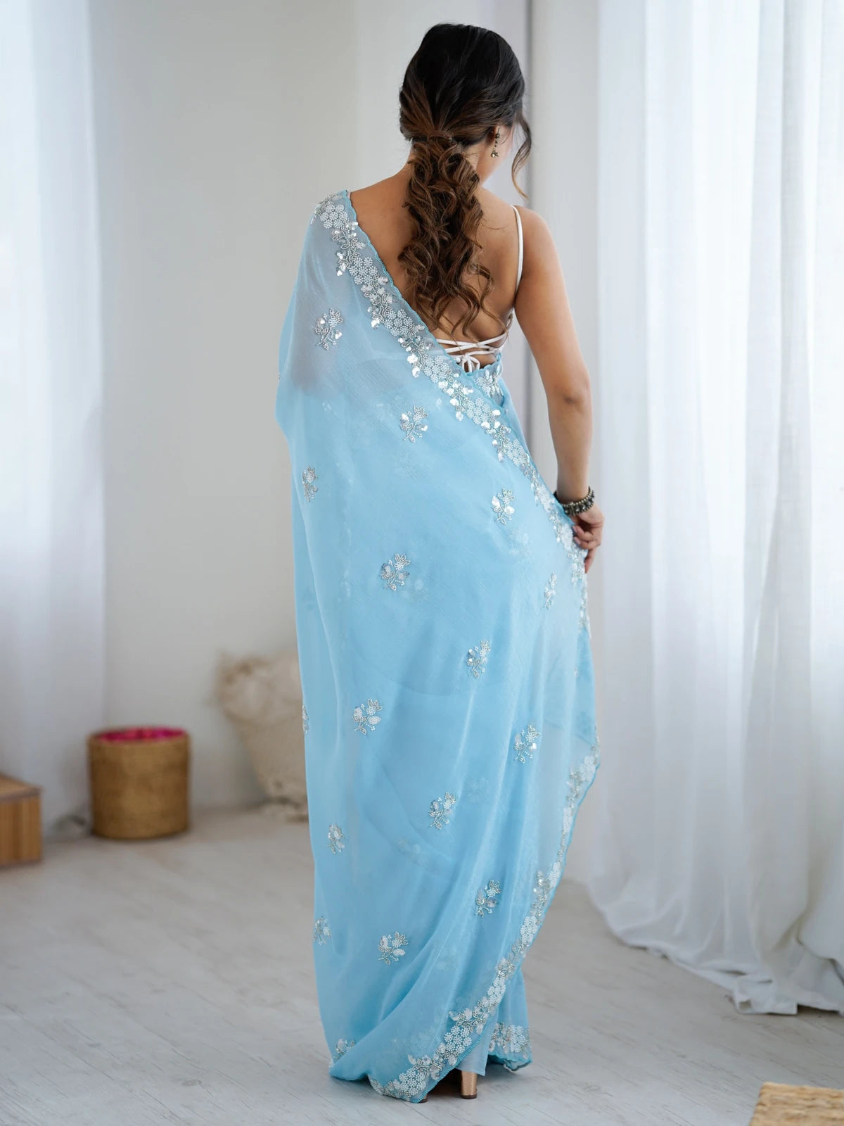 Tarani sky blue chiffon crush saree back view with embroidered border and blouse design