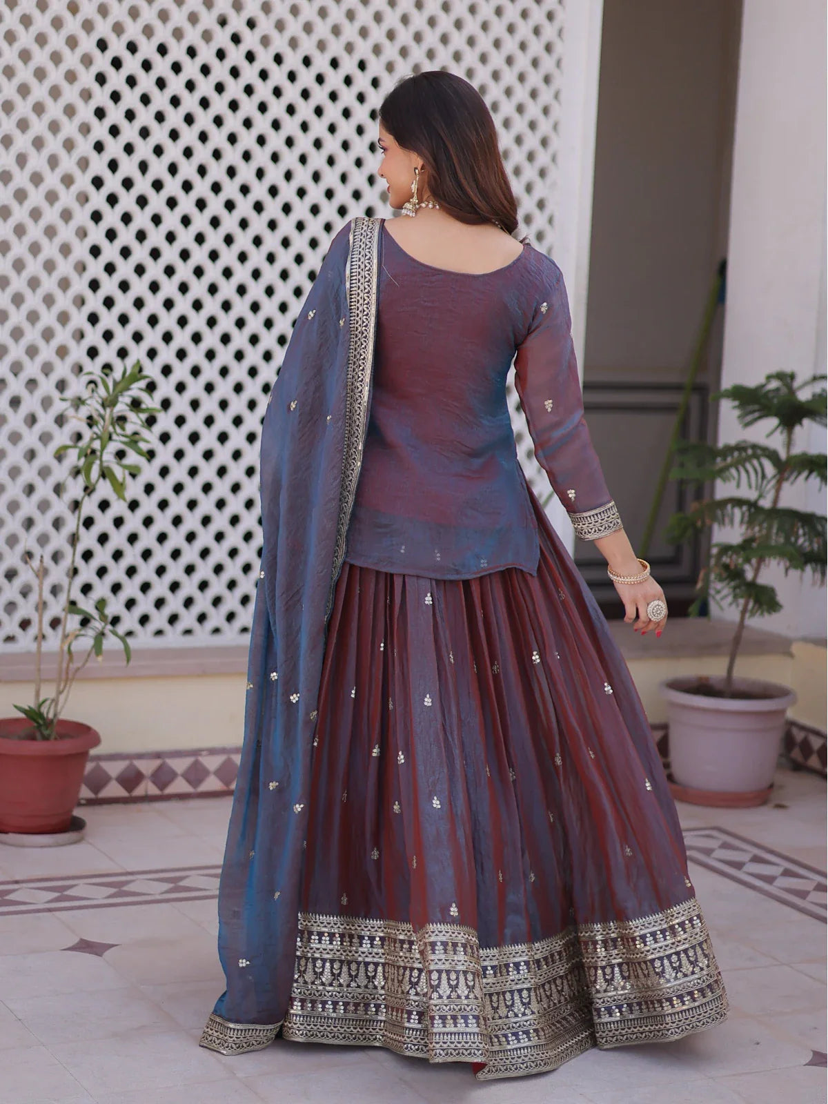 Tarani designer lehenga back view in maroon chiffon with elegant flare and detailed border