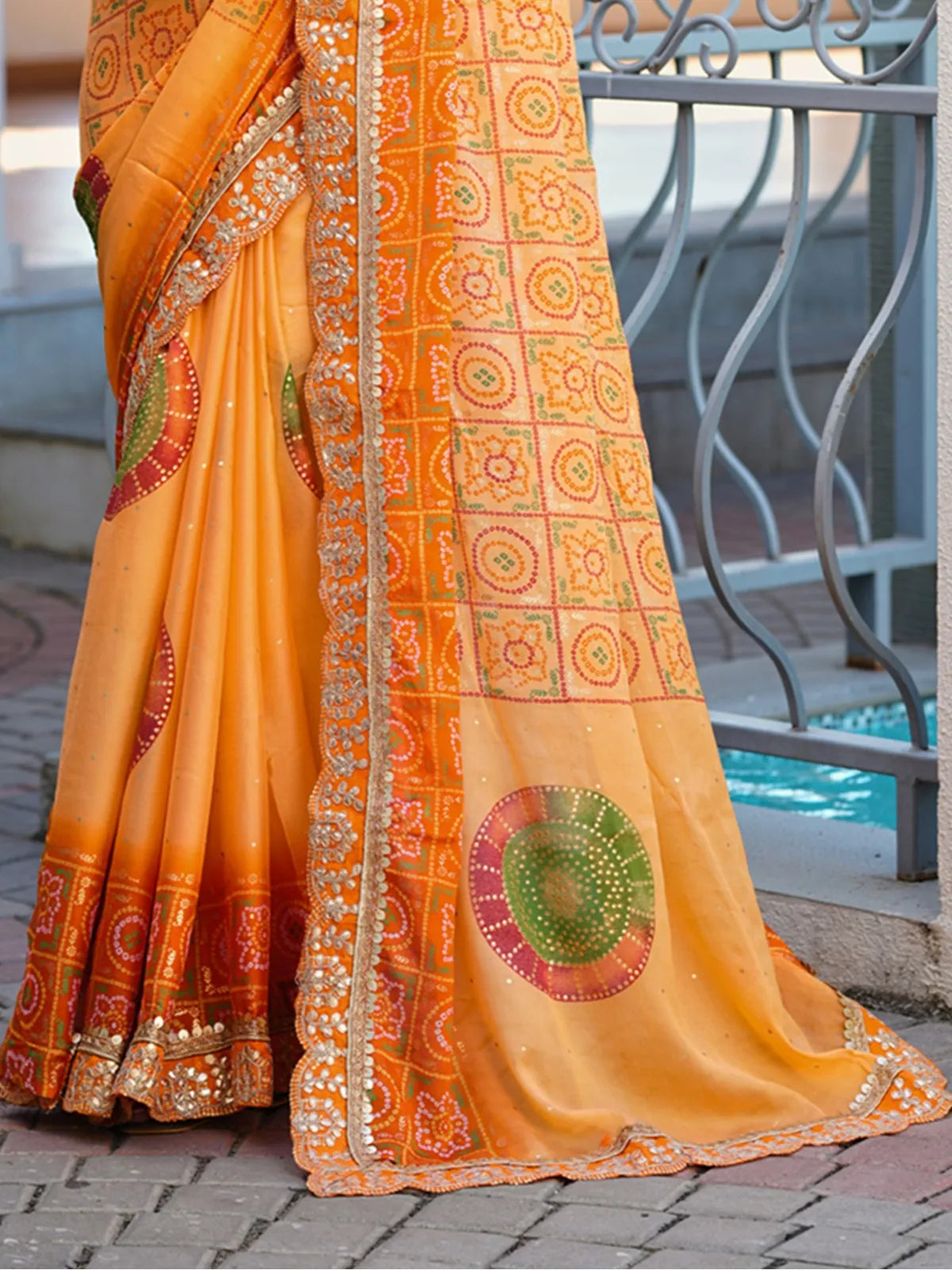 Tarani orange chiffon saree with heavy border and fabric closeup for casual or festive use