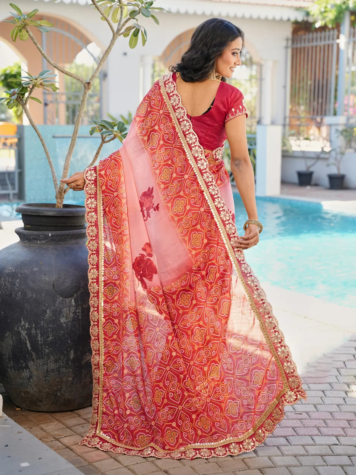 Back view of Tarani designer red chiffon saree with rich work and stylish blouse