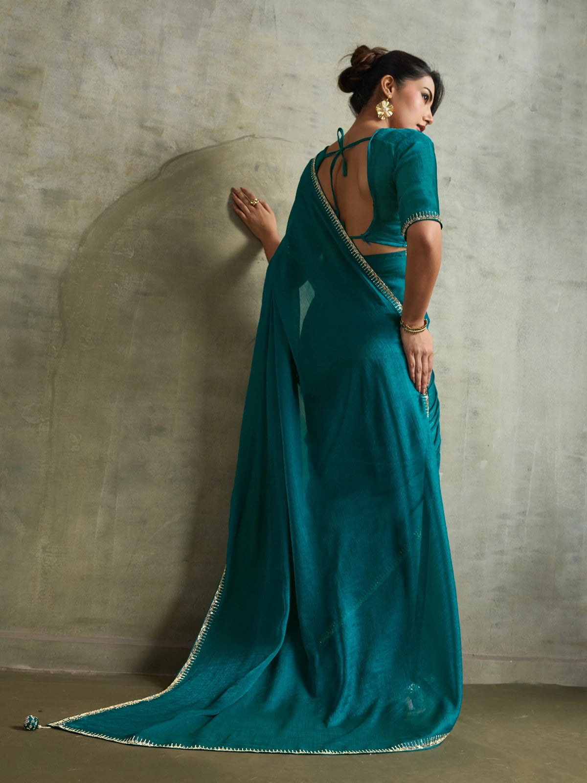 Tarani teal chiffon saree back blouse view with attached latkan and festive party styling