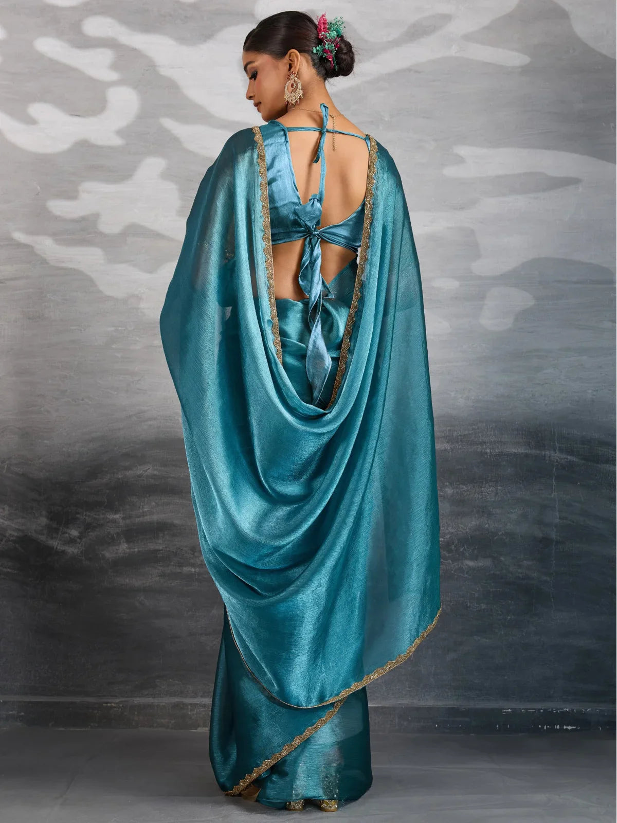 Tarani teal chiffon saree back view with stylish tie back blouse and lace border