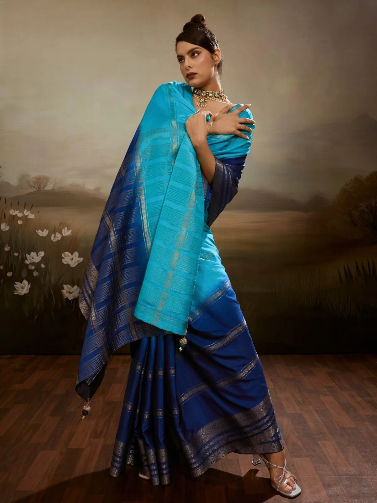 Tarani Urmika sky blue chiffon saree pallu view with zari woven border and tassels