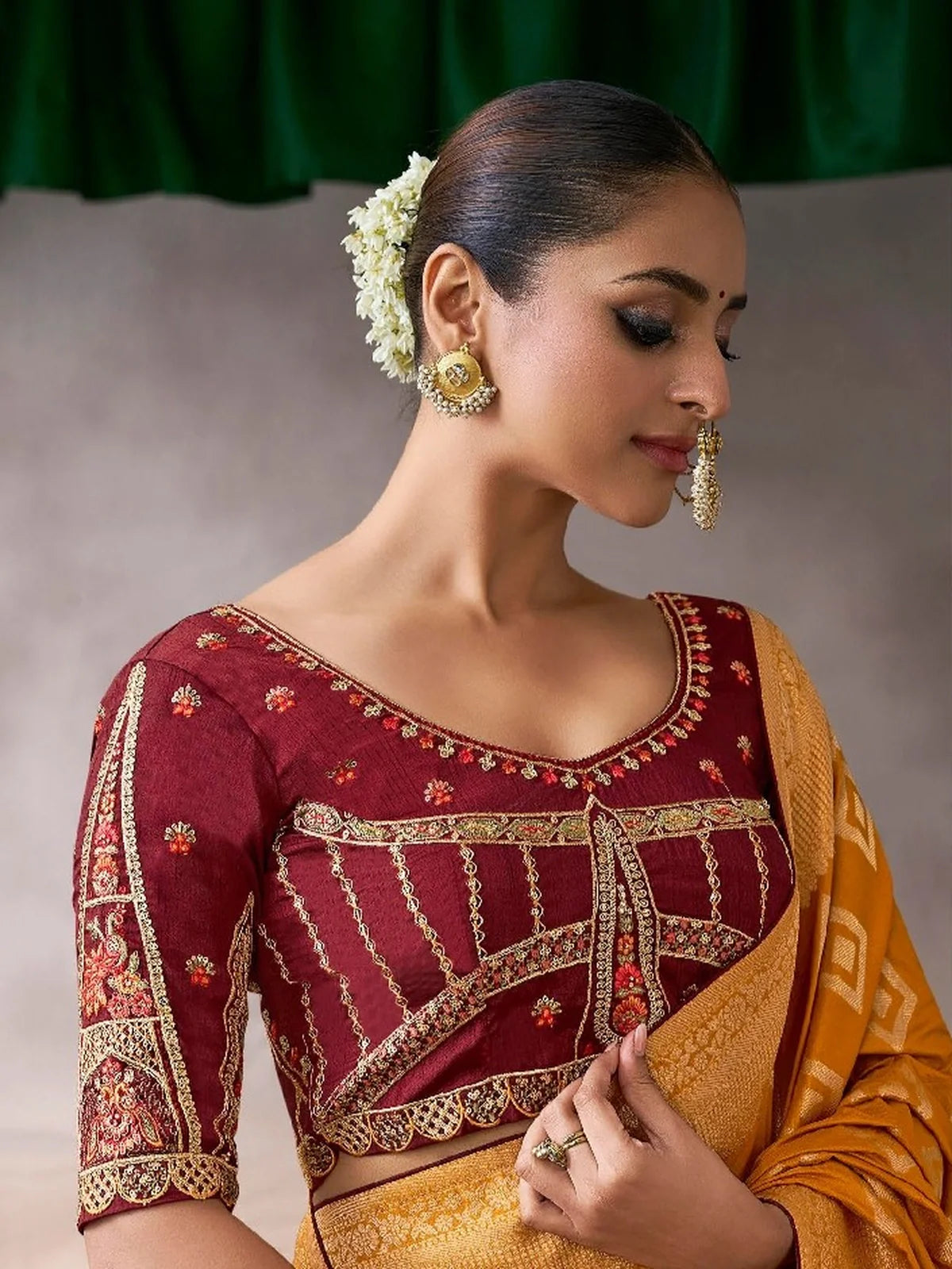 Tarani mustard chiffon silk saree upper body close-up with detailed maroon embroidered blouse