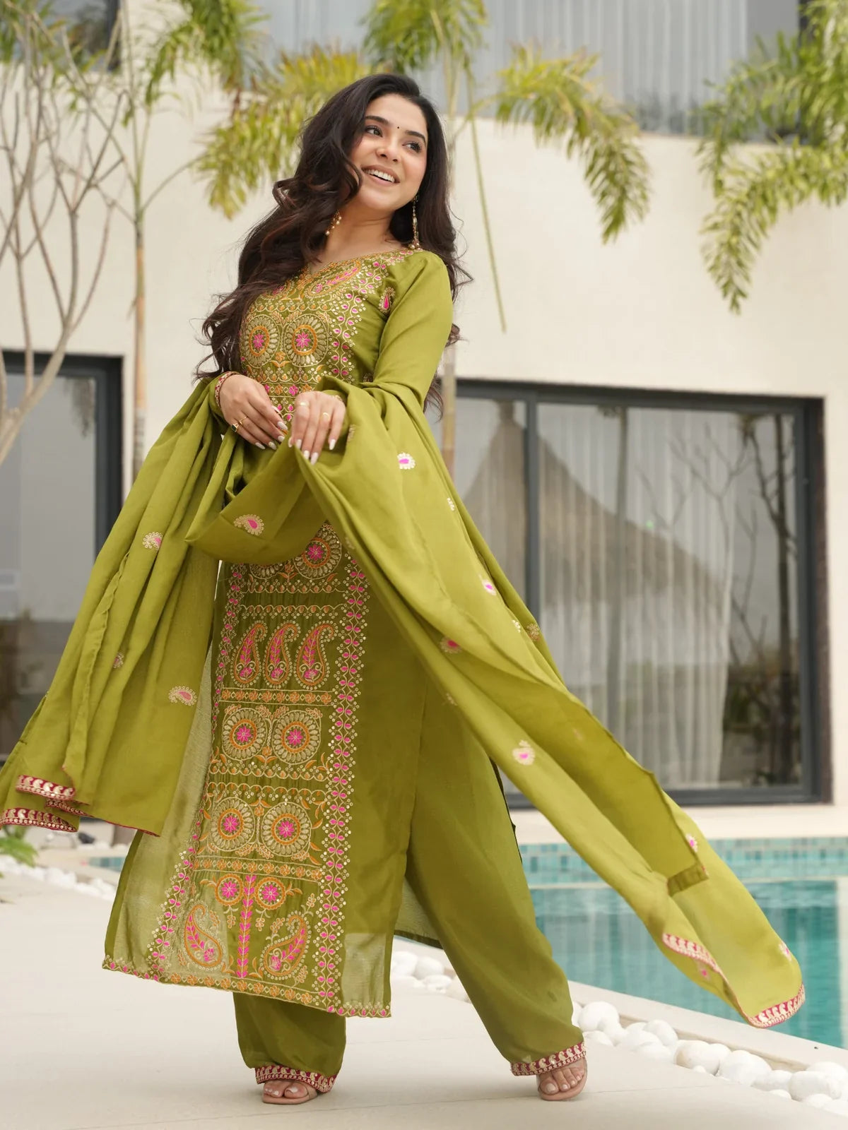 Front pose of Tarani green Chinnon embroidered dress with dupatta and ethnic detailing