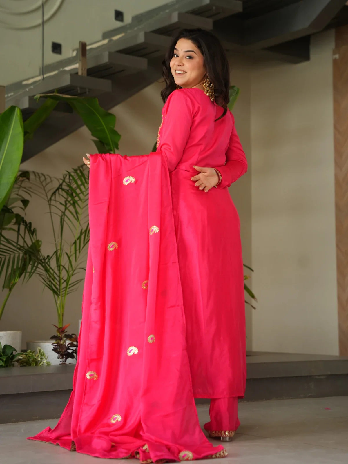 Back view of Tarani pink chinnon embroidered dress with full-length dupatta and subtle zari motifs