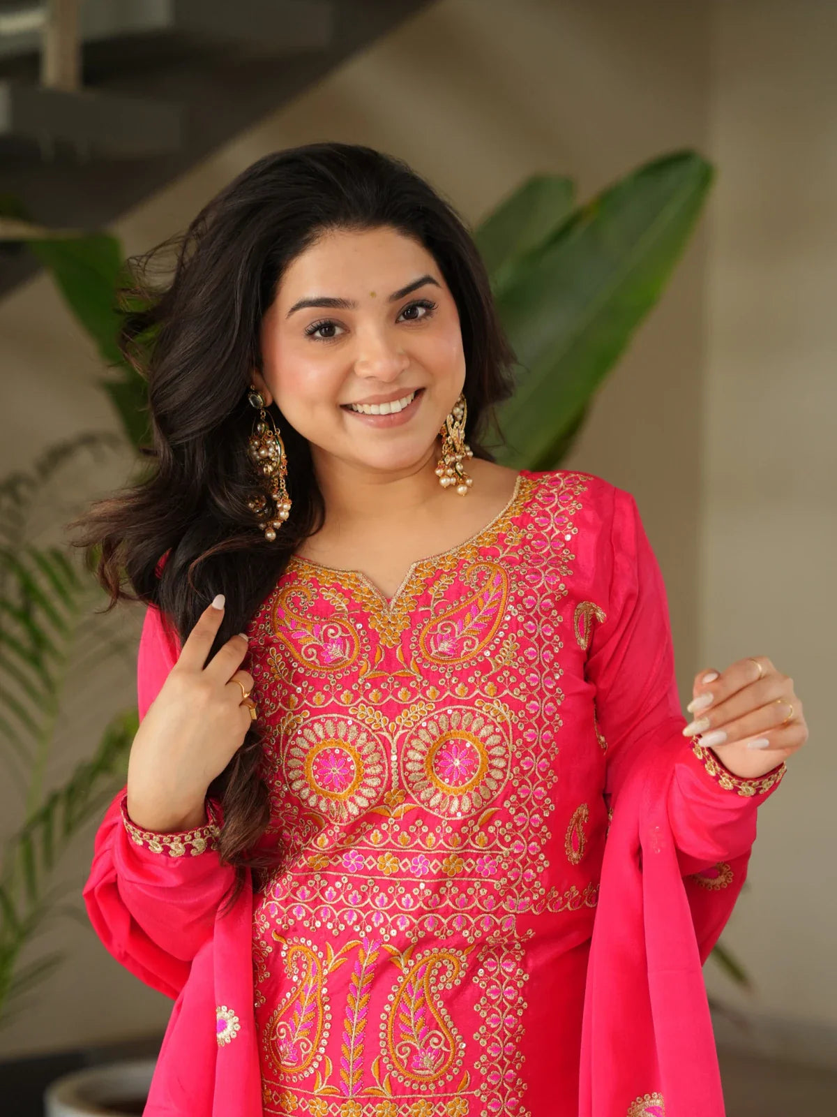 Tarani pink chinnon embroidered dress with detailed neckline and sleeve work shown in upper body closeup