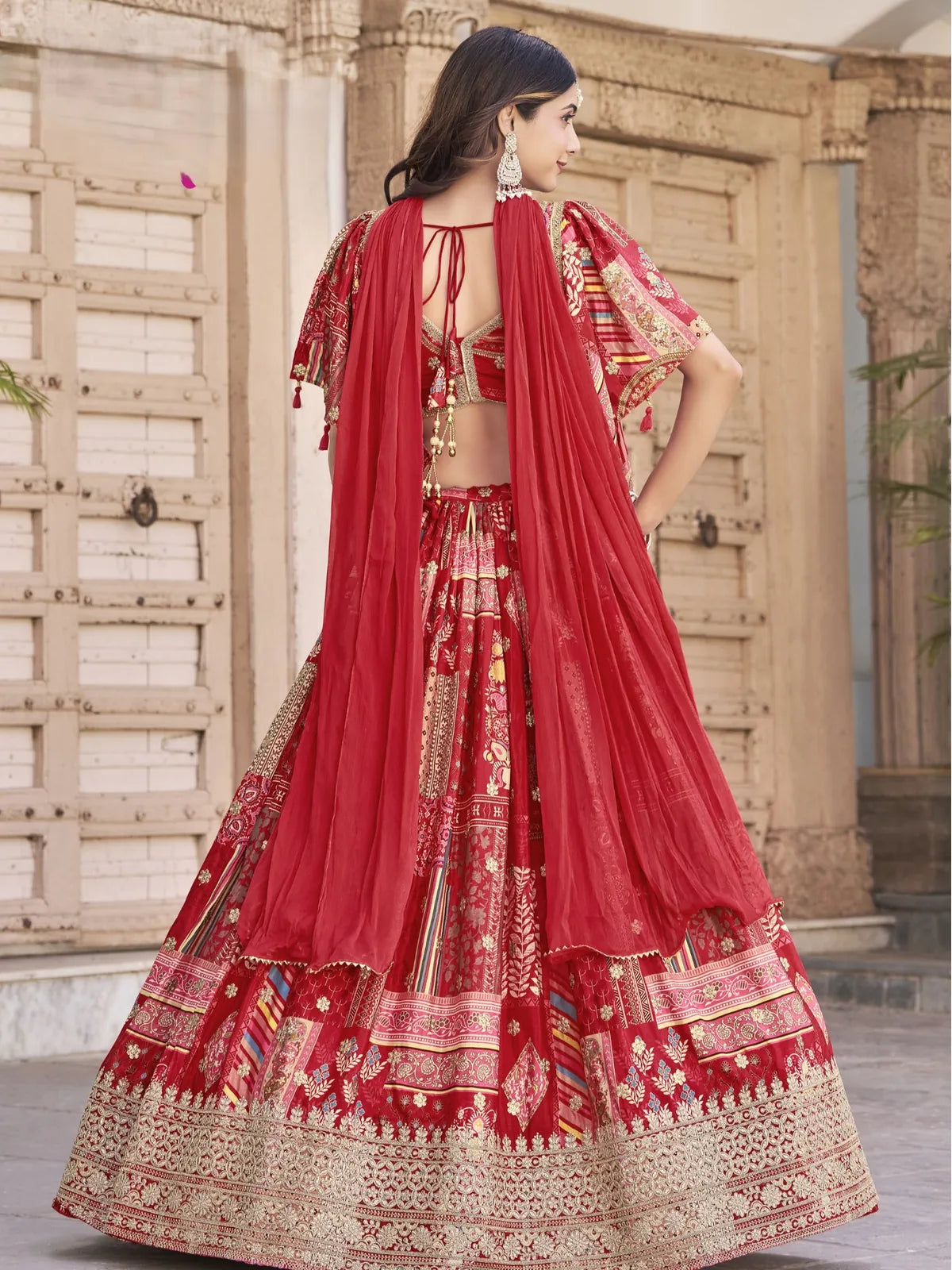 Tarani back view of red lehenga set with chiffon dupatta and embroidered blouse