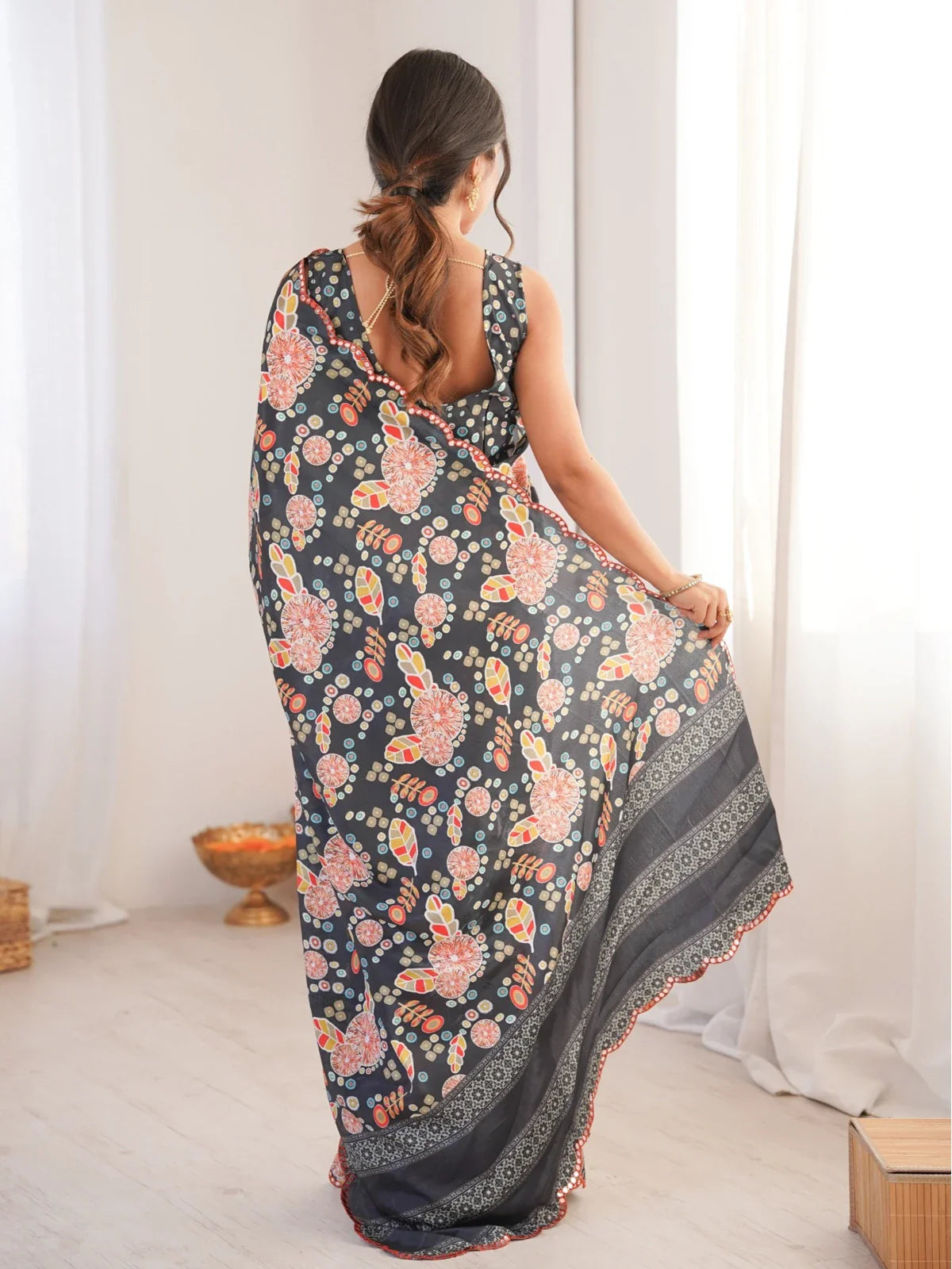 Tarani black saree back view with printed chinnon fabric and sleeveless blouse