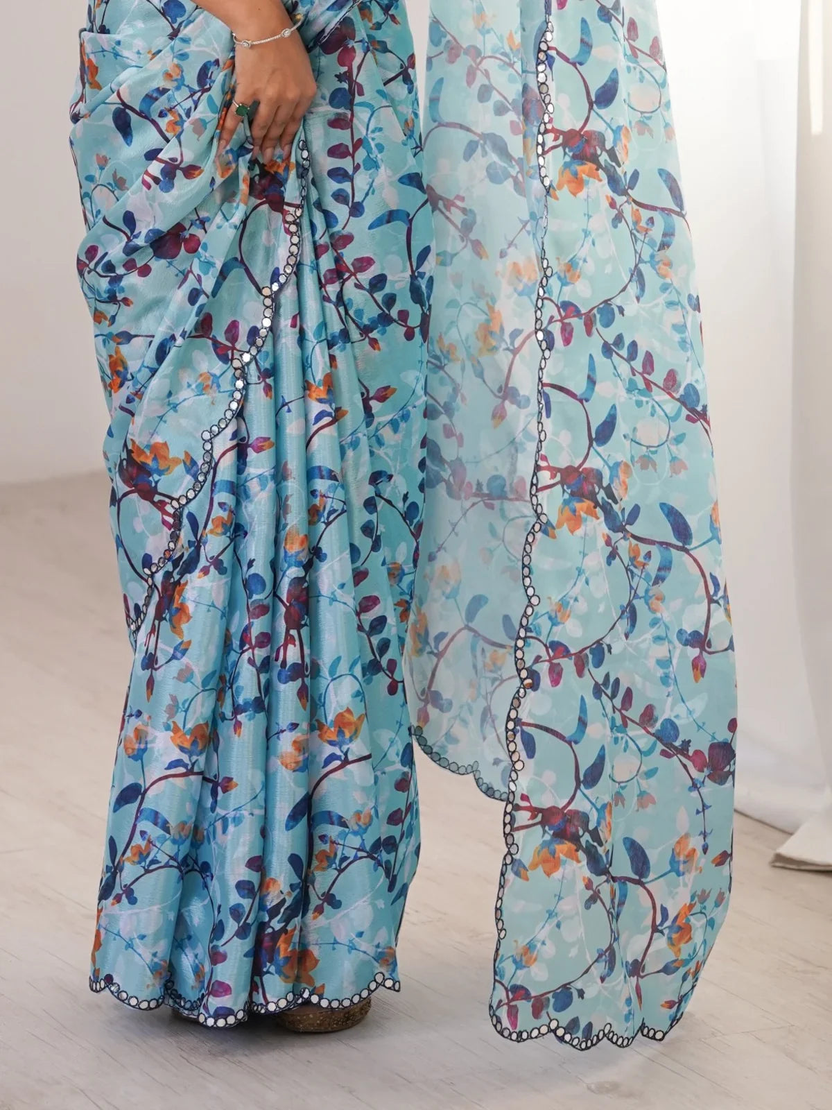 Tarani designer blue saree with printed floral motifs and detailed pallu scalloped border