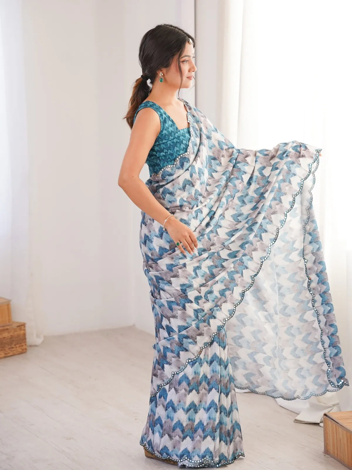 Tarani blue chinnon saree side view highlighting graceful fall and scallop border