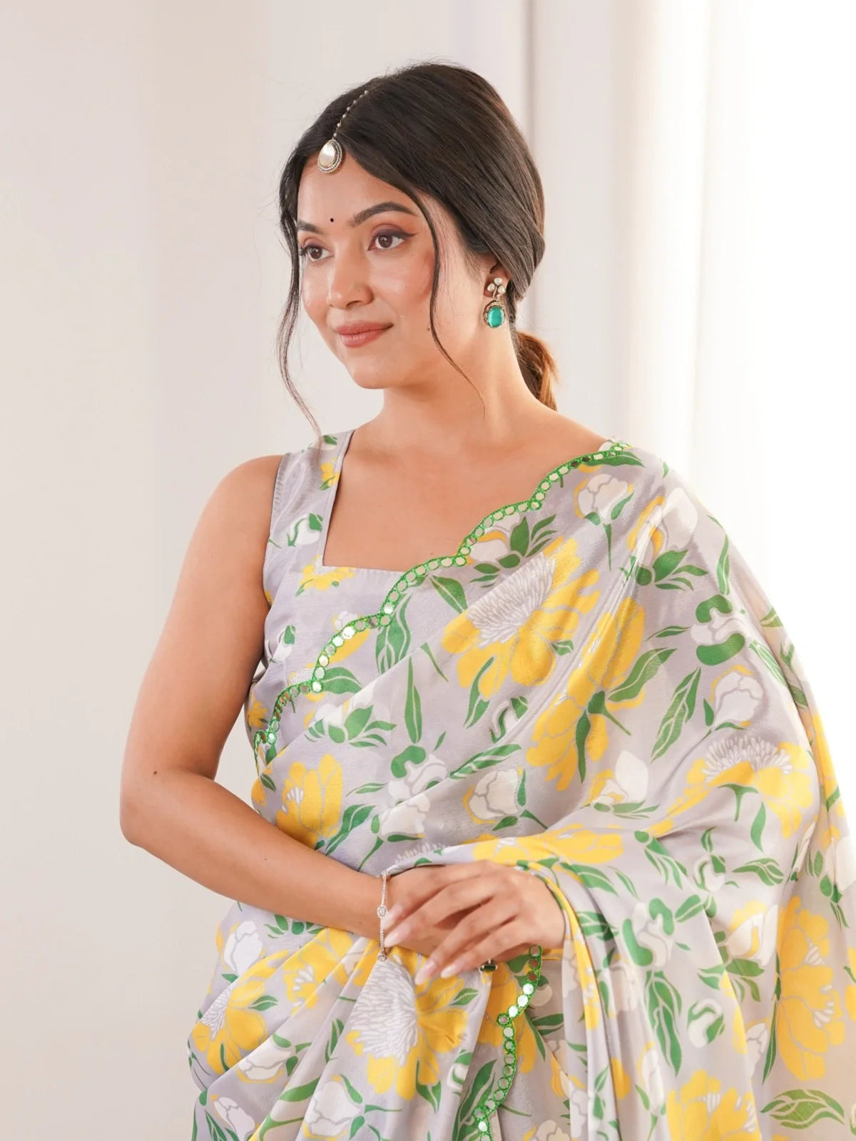 Tarani yellow floral chinnon saree upper body view with green mirror border and sleeveless blouse