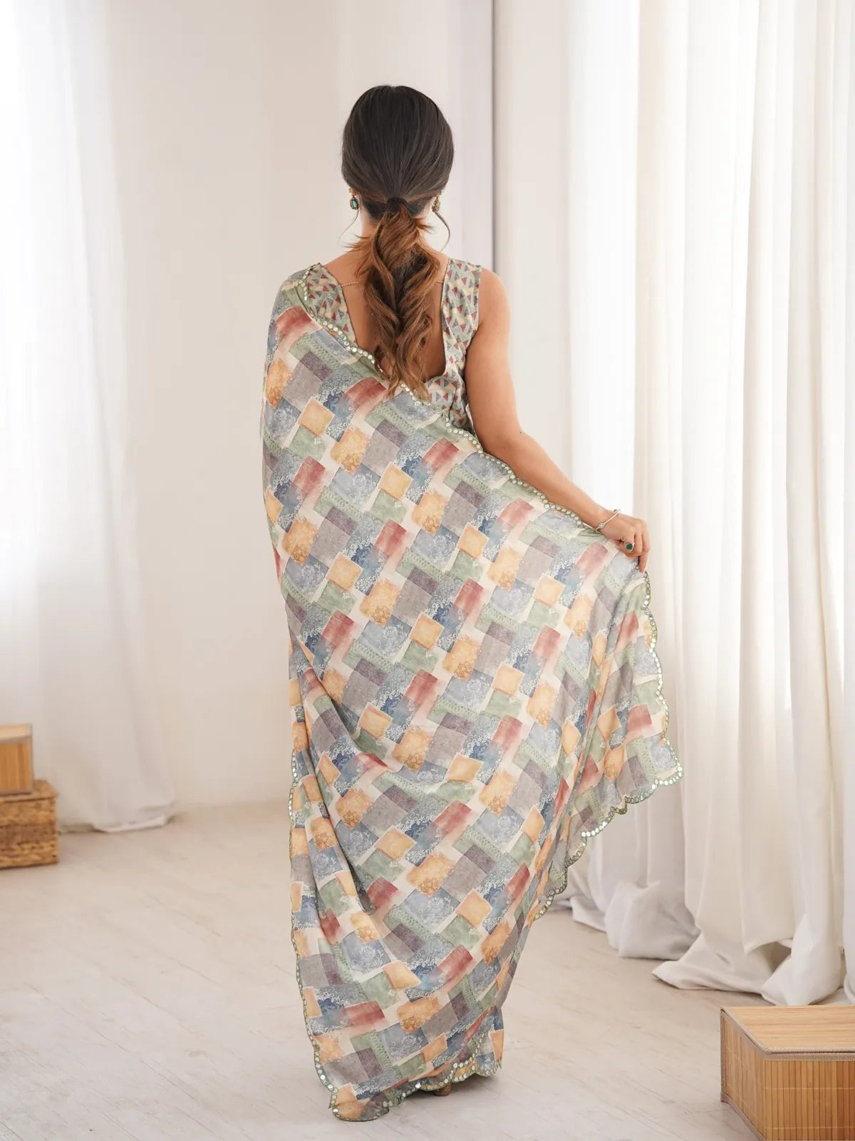 Tarani back view of chinnon saree highlighting blouse and full drape fall