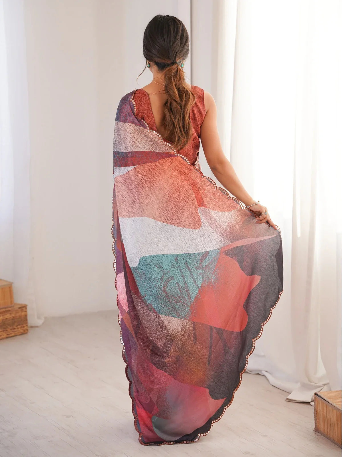 Tarani back view of multicolor saree showing blouse design and pallu fall in soft light