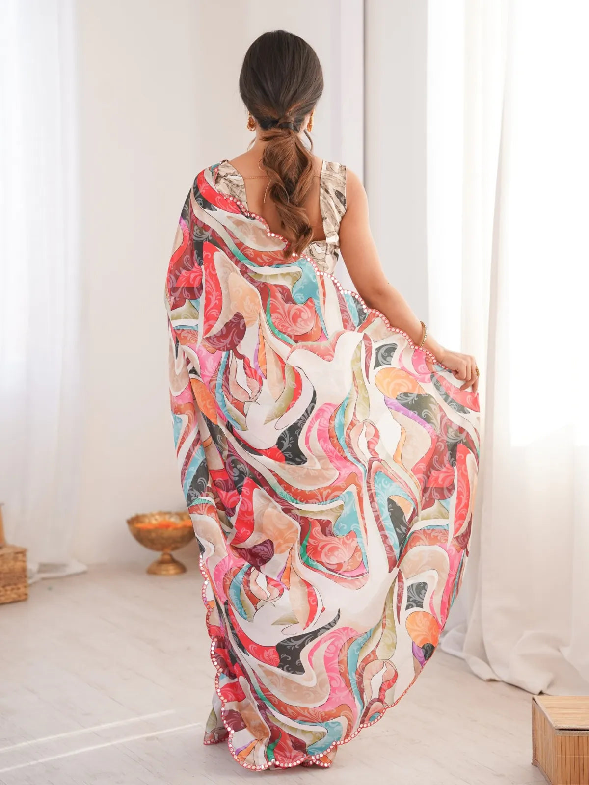 Tarani saree back view showcasing mirror border and colorful print work
