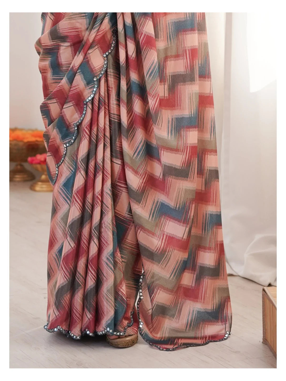 Tarani closeup showcasing chinnon saree fabric texture and mirror embroidered border