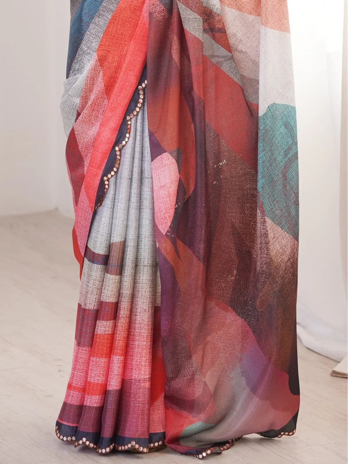 Tarani pallu view of multicolor printed chinnon saree with elegant drape and mirror edging