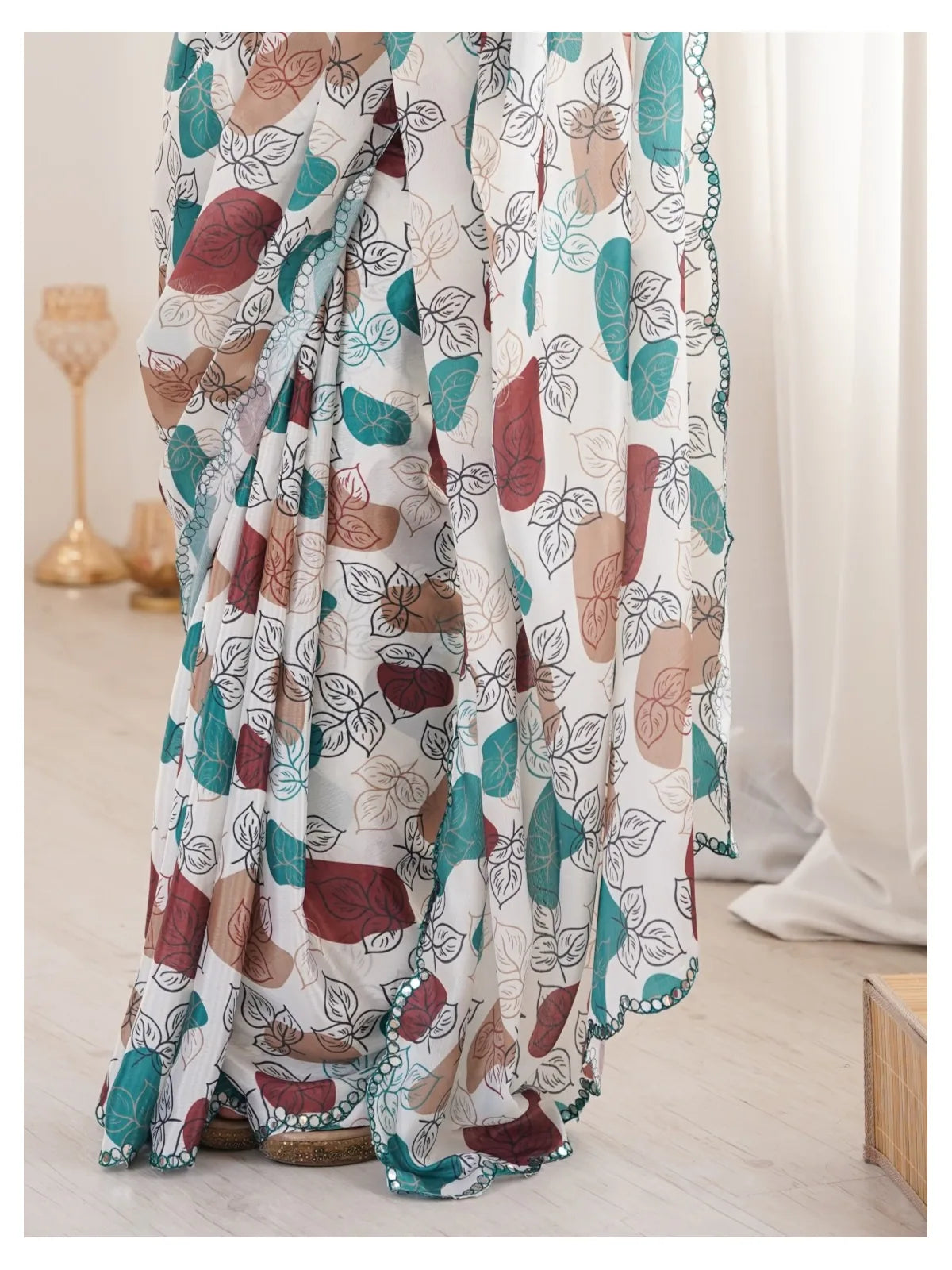 Tarani off white heavy chinnon saree closeup-view showcasing print and mirror border