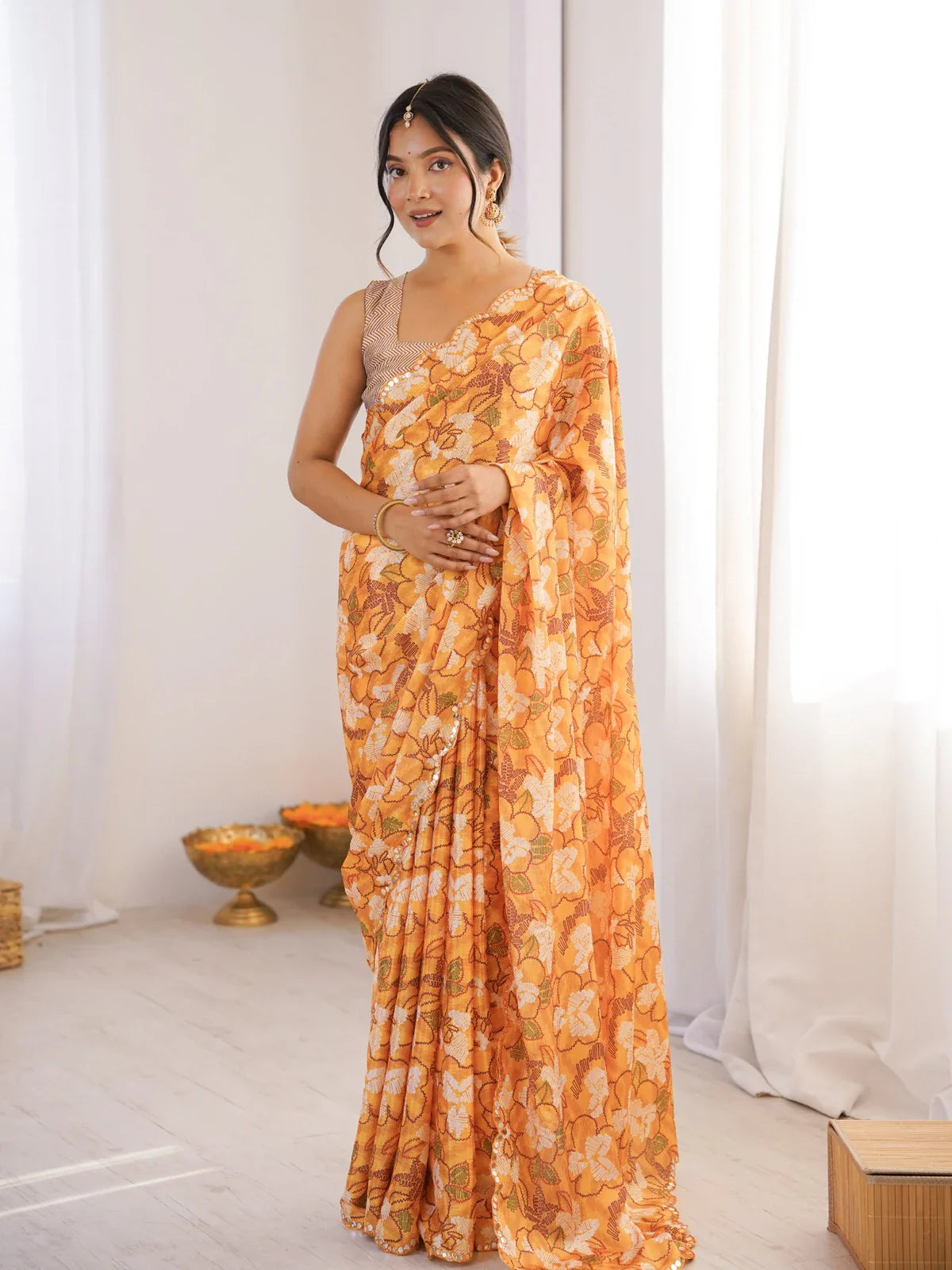 Tarani vibrant orange chinnon saree full view with floral print and mirror border