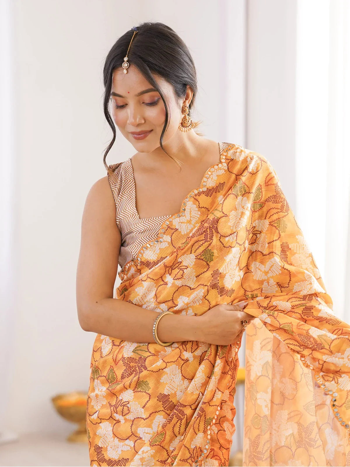 Tarani chinnon saree upper body shot showing floral drape and printed blouse