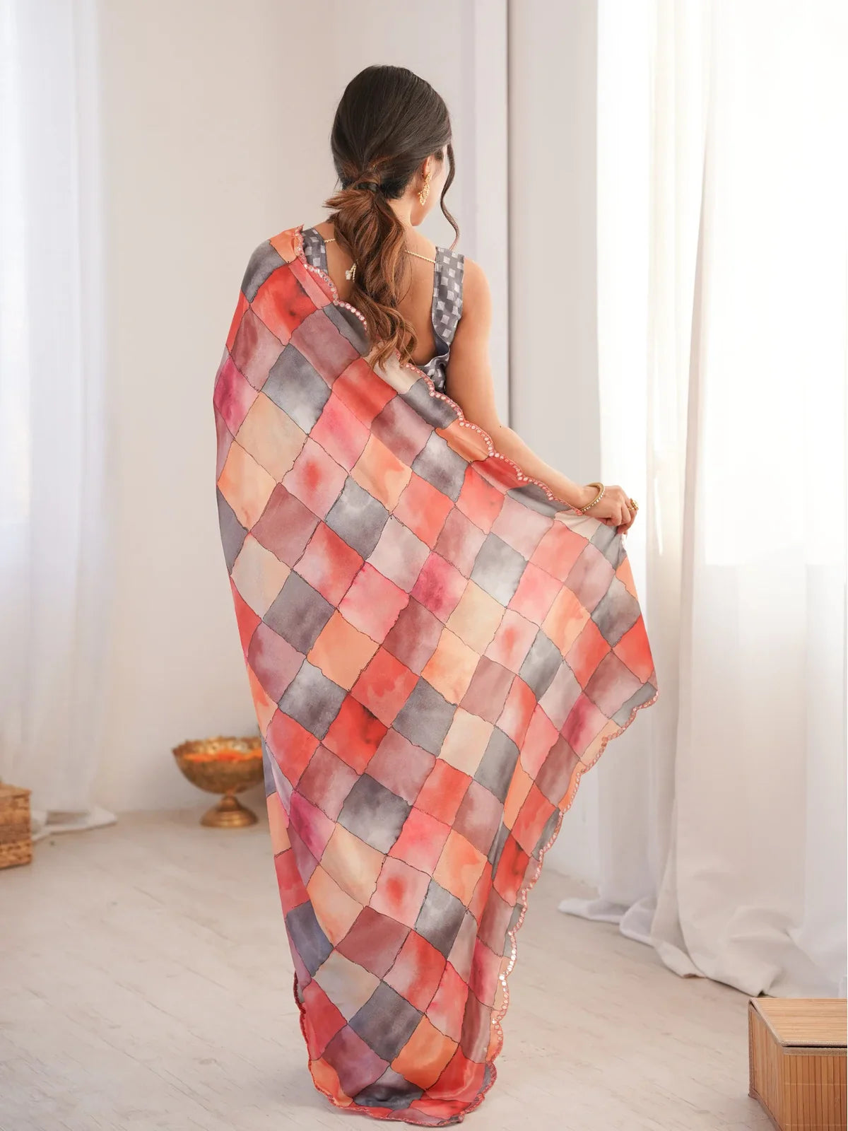 Tarani peach printed chinnon saree back view with artistic panel design and subtle shine