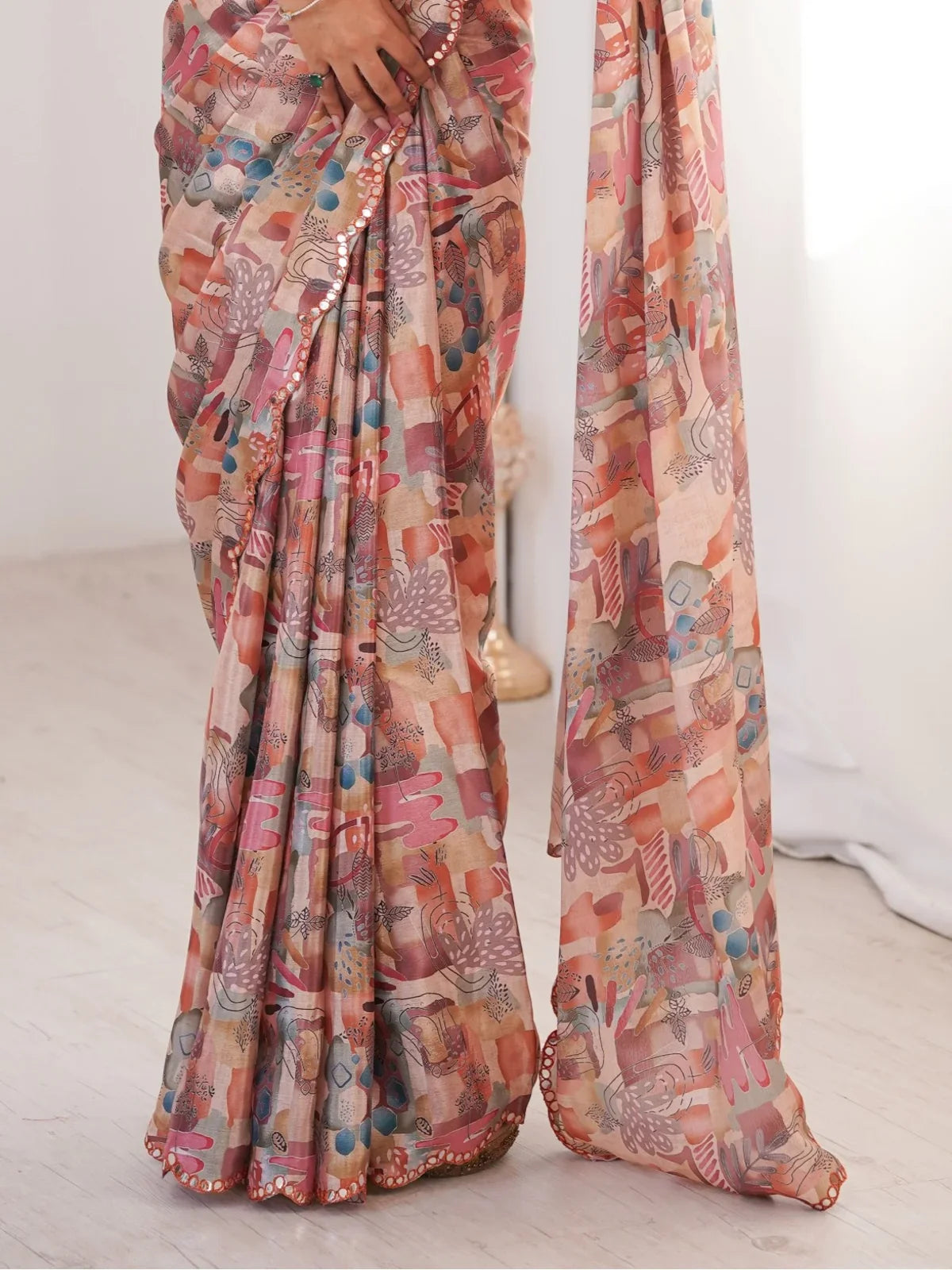 Tarani peach printed chinnon saree closeup view view showing design and drape