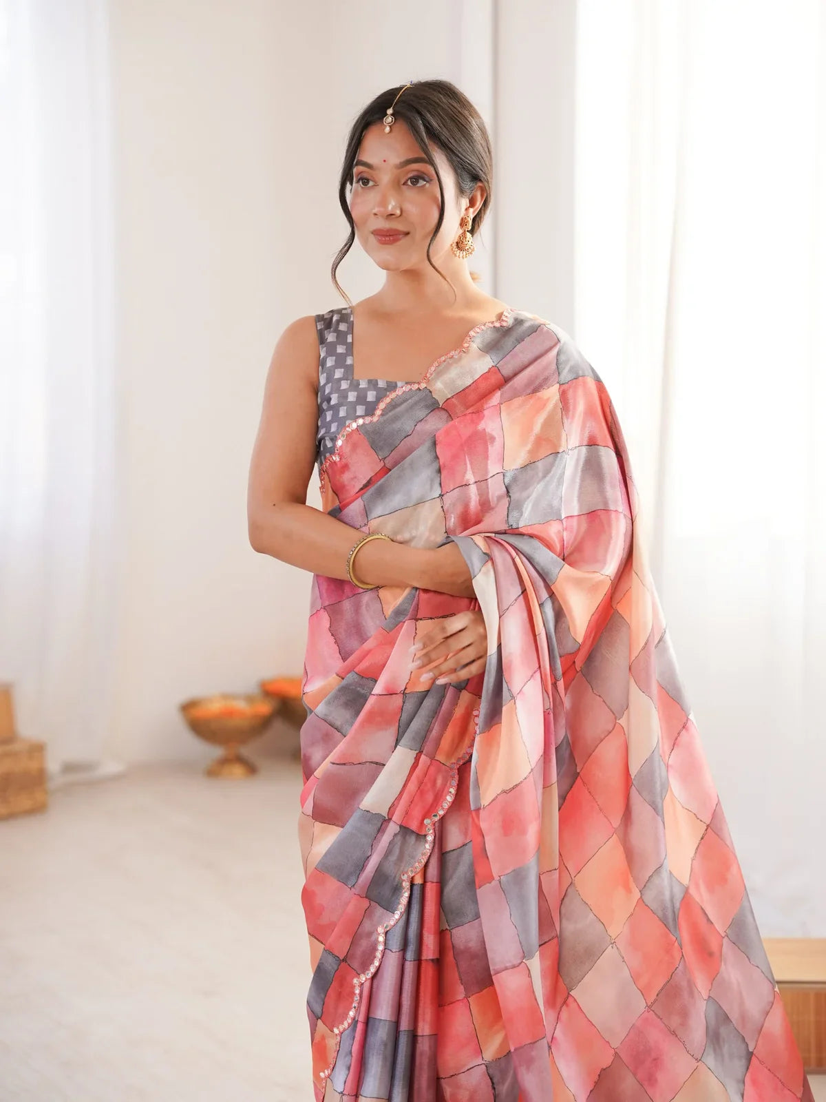 Tarani peach saree front view showcasing printed design and scalloped border for festive styling