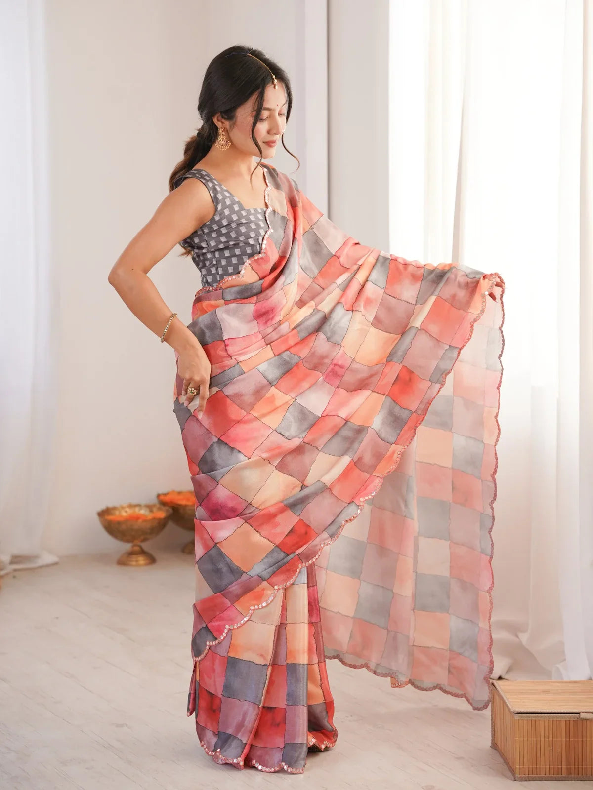 Tarani peach saree side pose with graceful drape and elegant festive appeal