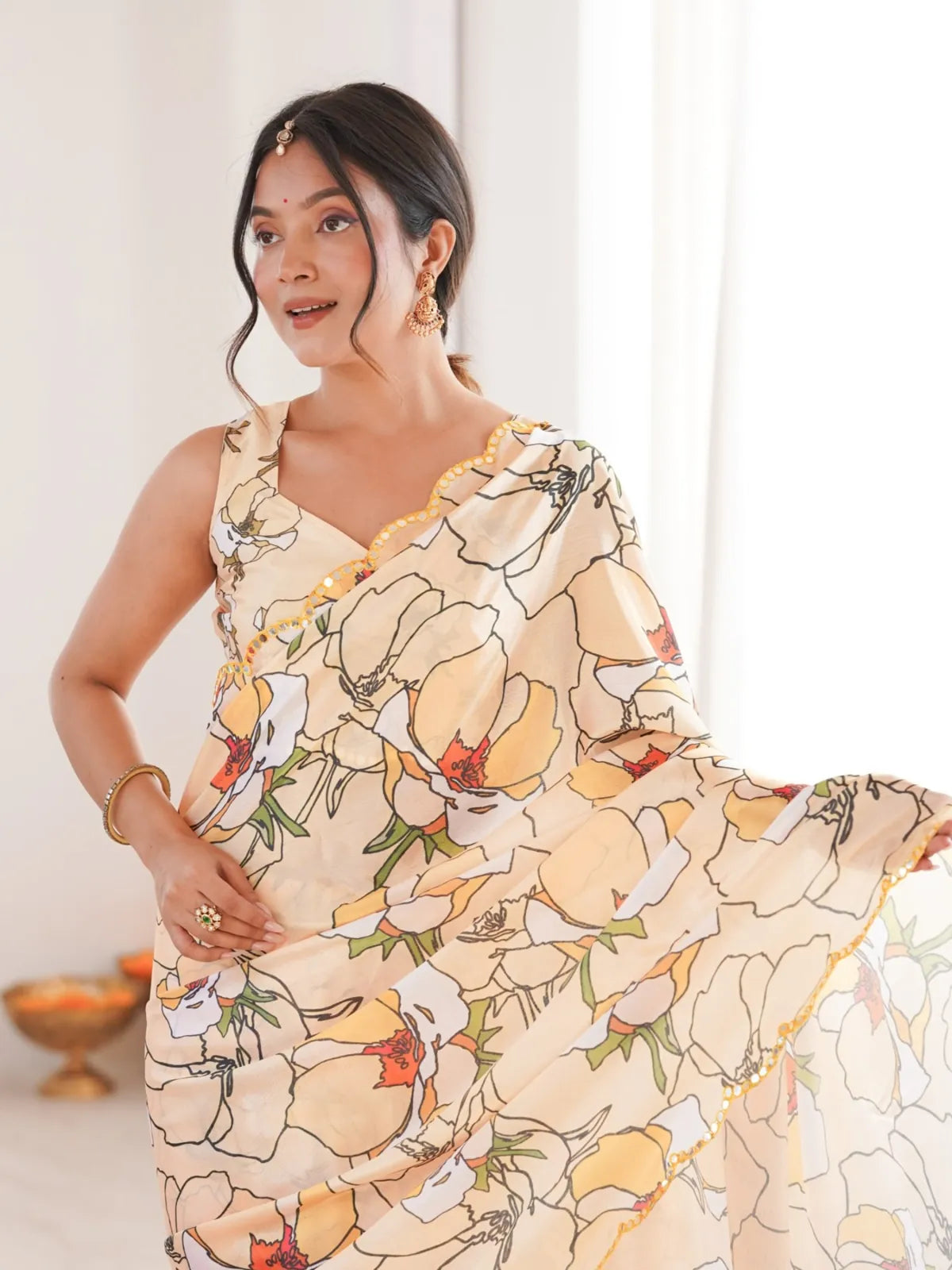 Tarani peach chinnon saree with upper body view showcasing printed floral design and mirror work border