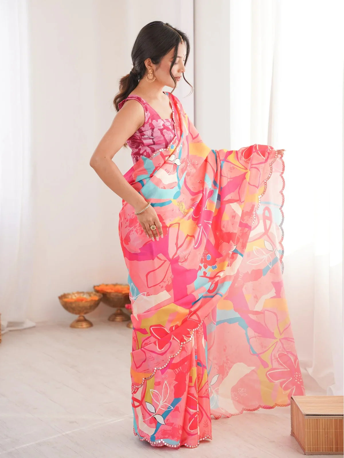 Tarani pink chinnon saree side pose showing silhouette and elegant mirror border design