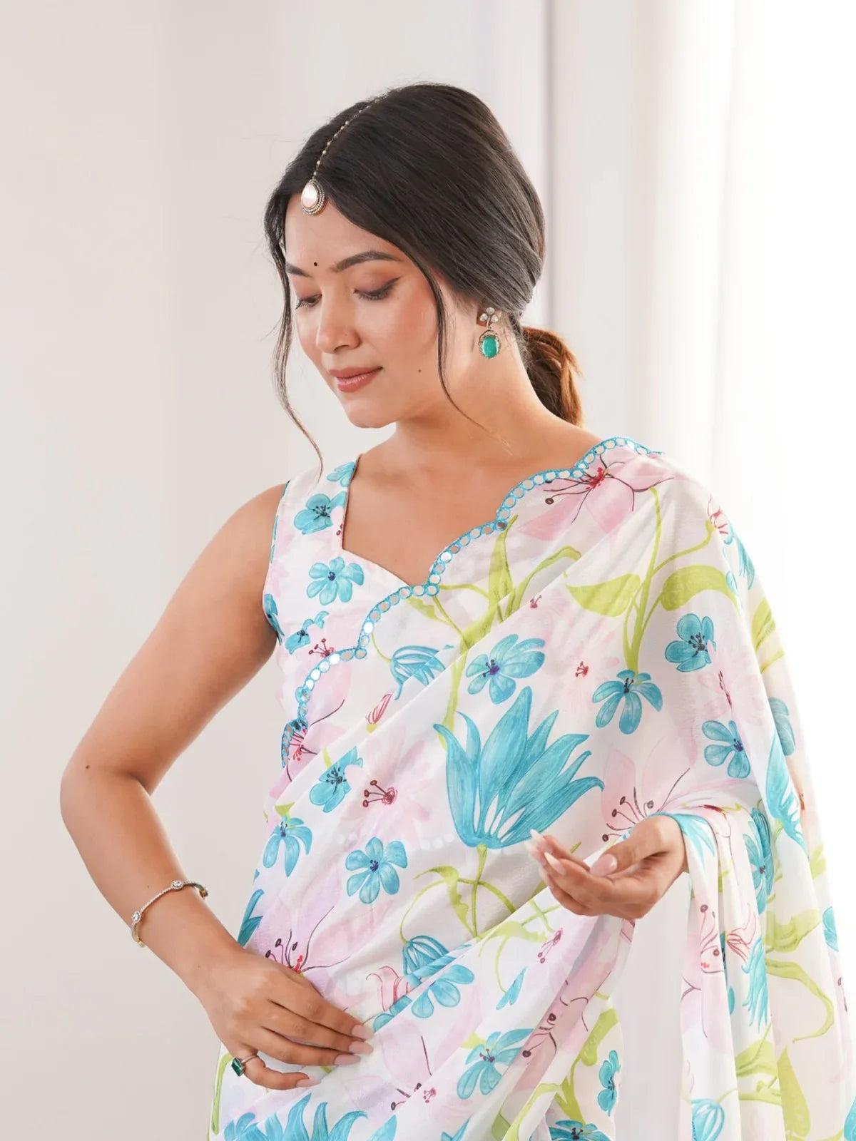 Tarani white floral chinnon saree showing elegant neckline and upper drape with mirror border