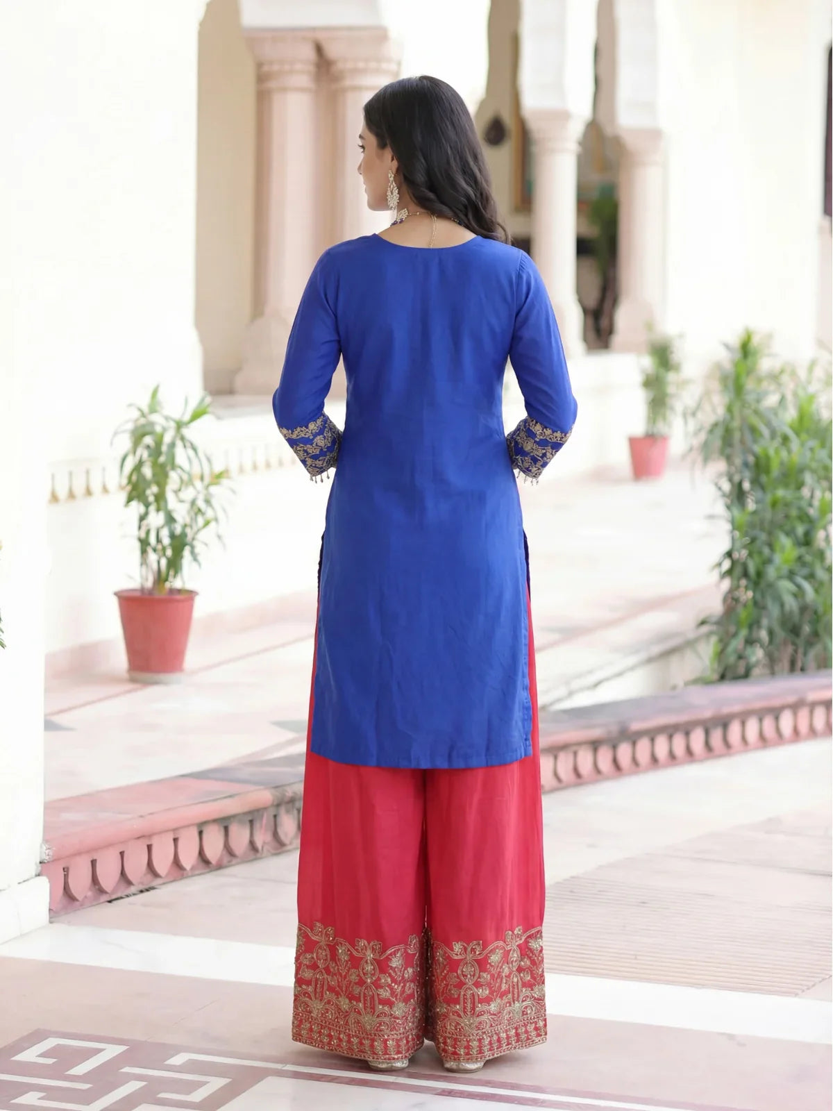 Tarani back view of chinon dress showing clean stitch and vibrant red palazzo