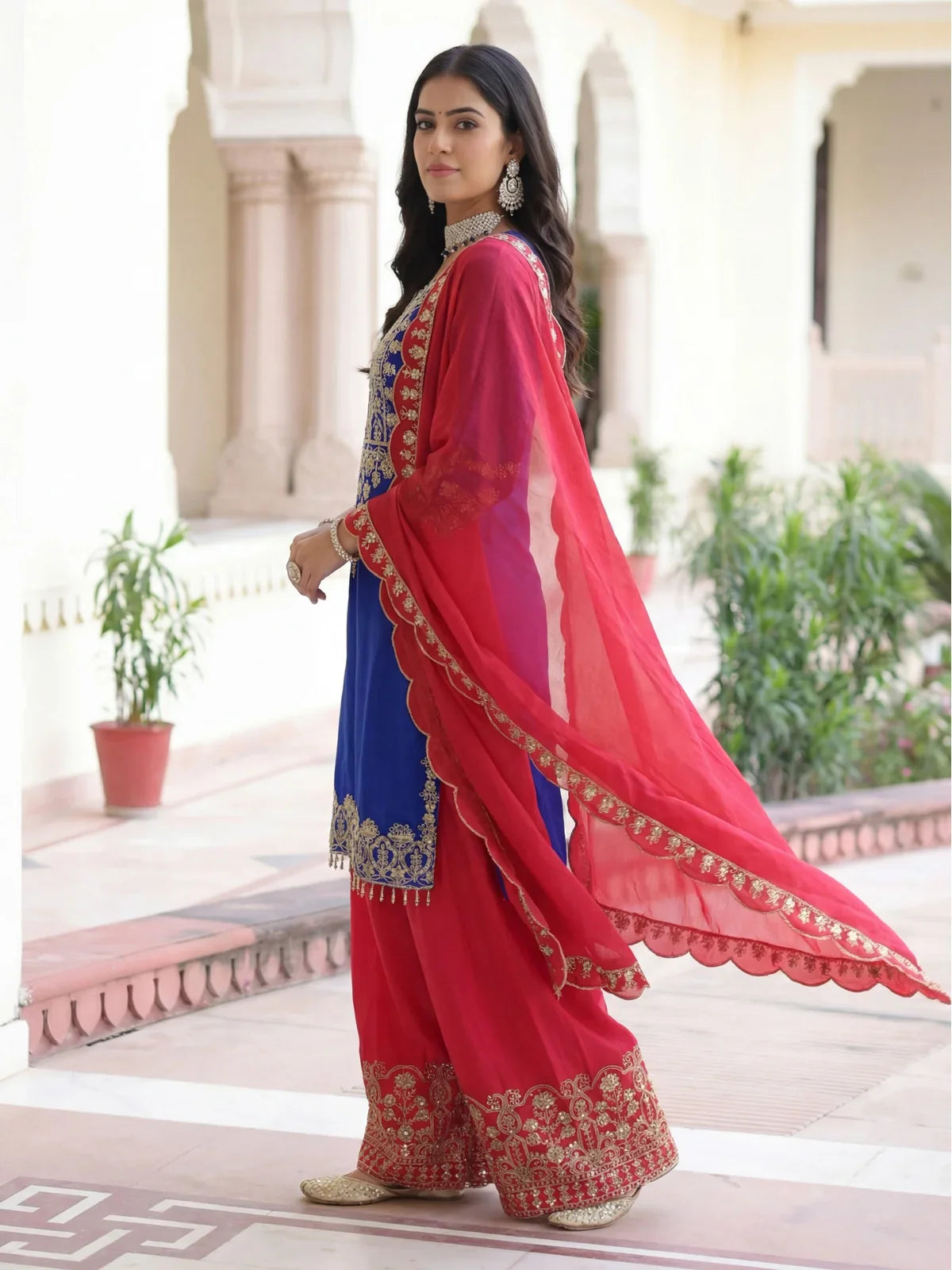 Tarani side profile of blue chinon dress with elegant red dupatta flow