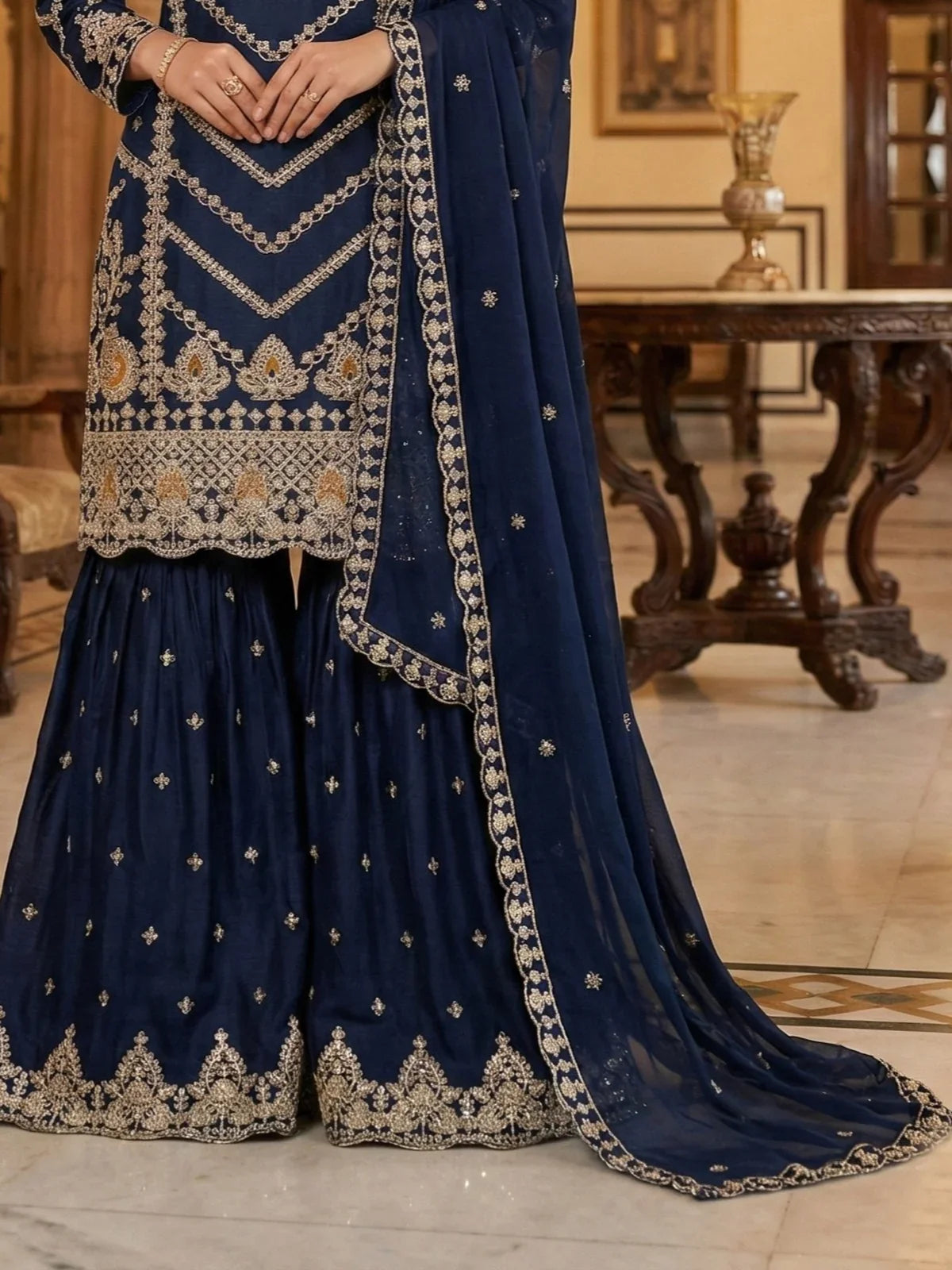 Tarani chinon navy blue sharara suit showing golden embroidery work - closeup view