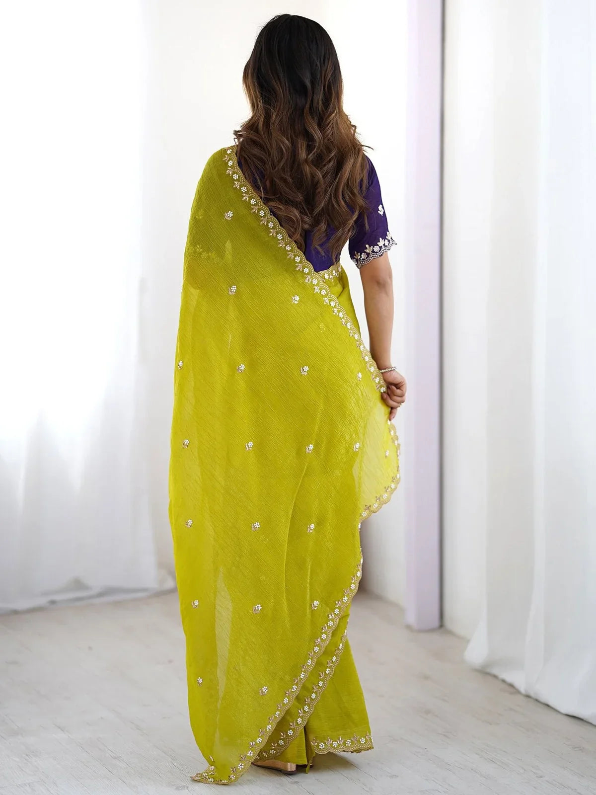 Tarani green soft drape saree with zari pearl border shown from the back