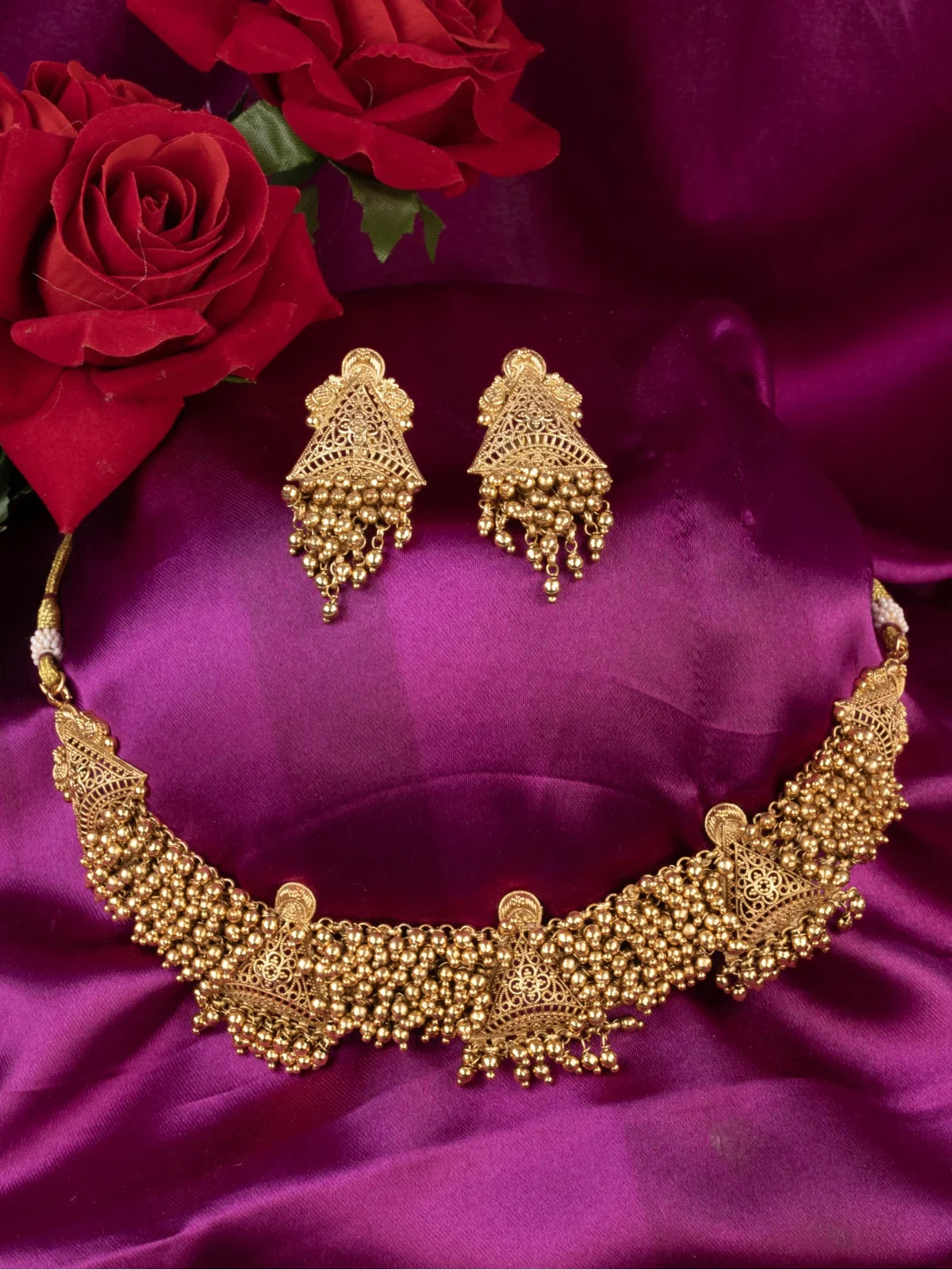 Tarani designer gold choker set with intricate beaded antique design and earrings