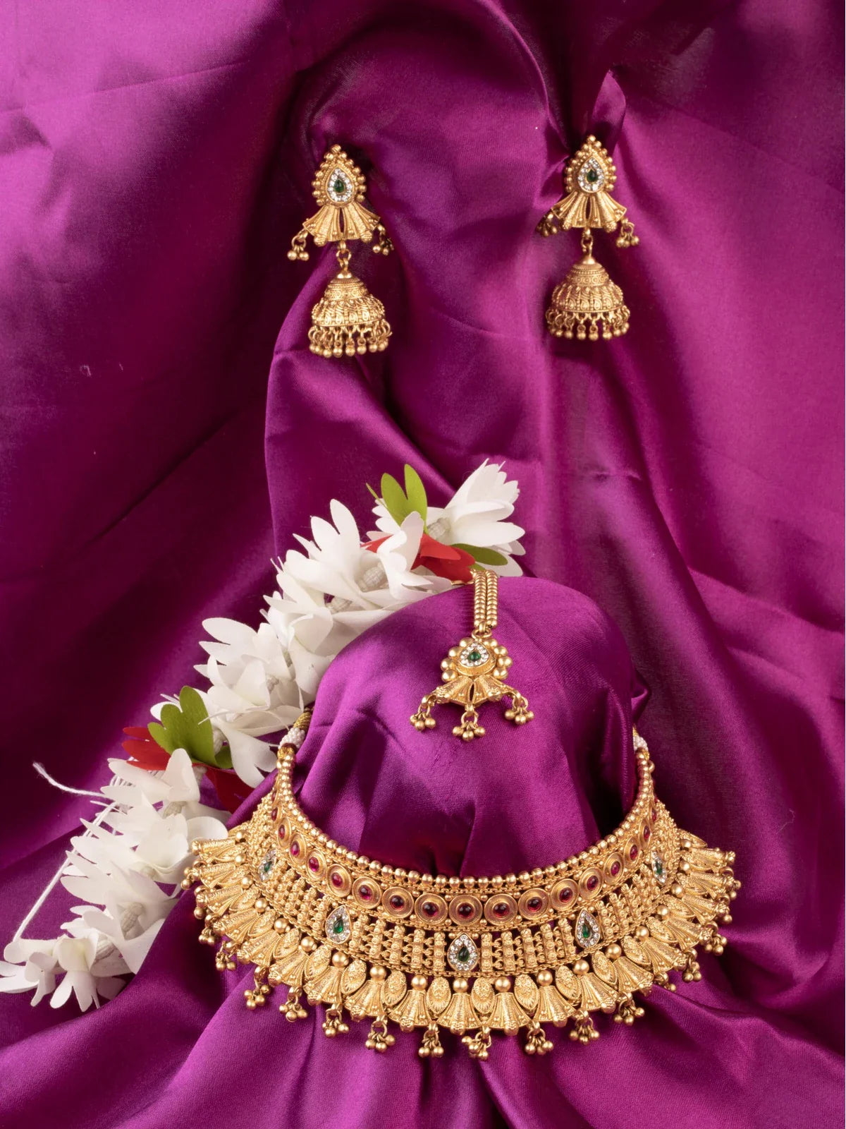 Tarani designer gold plated choker set with stone work and matching earrings for weddings