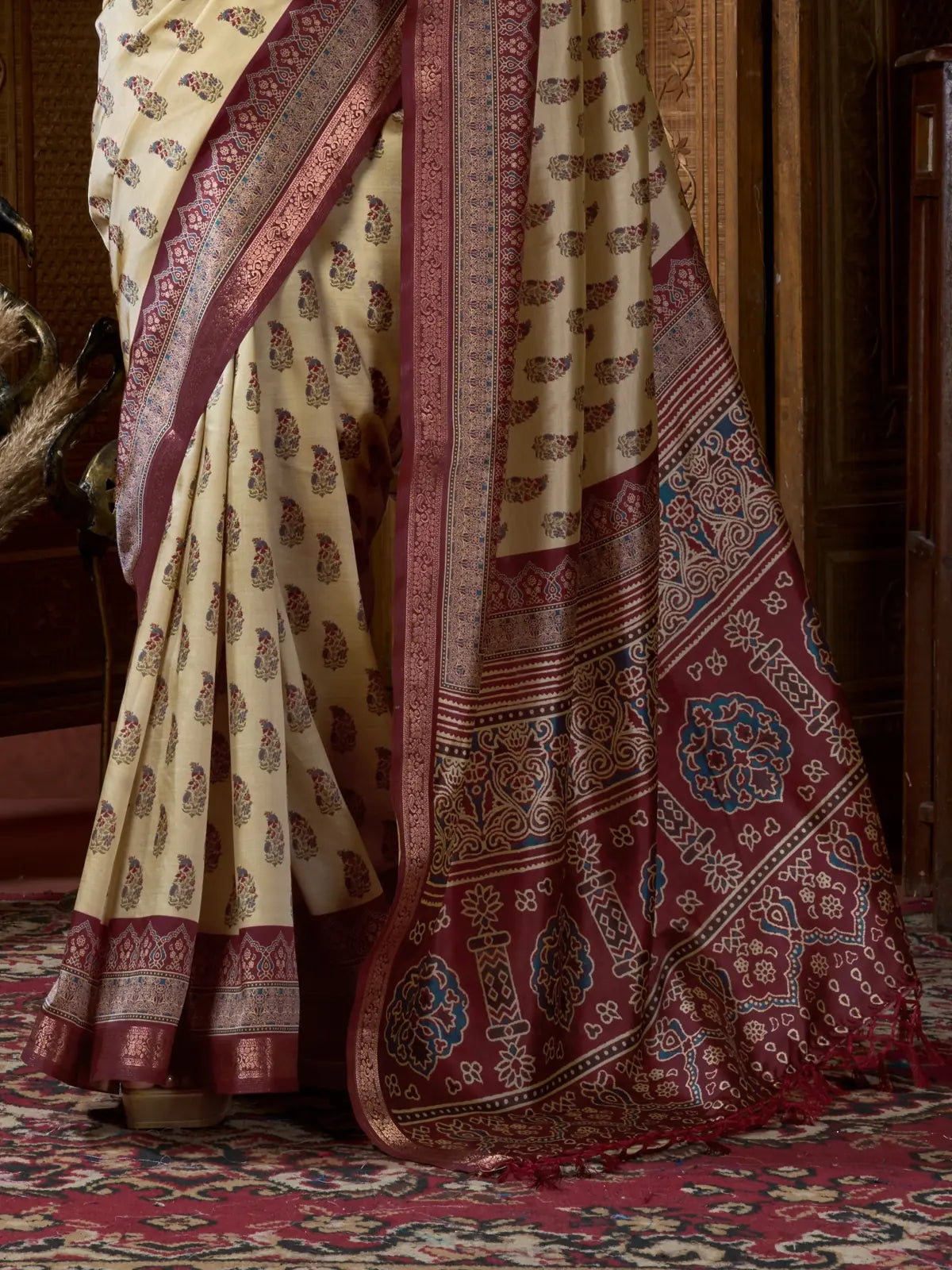 Tarani ajrak digital saree close up showing rich maroon pallu and tassels